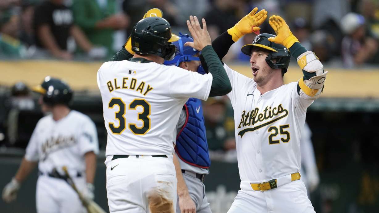 Oakland Athletics’ Brent Rooker, right, celebrates with JJ Bleday (33) after hitting a two-run home run against the Los Angeles Dodgers during the fifth inning of a baseball game Friday, Aug. 2, 2024, in Oakland, Calif.