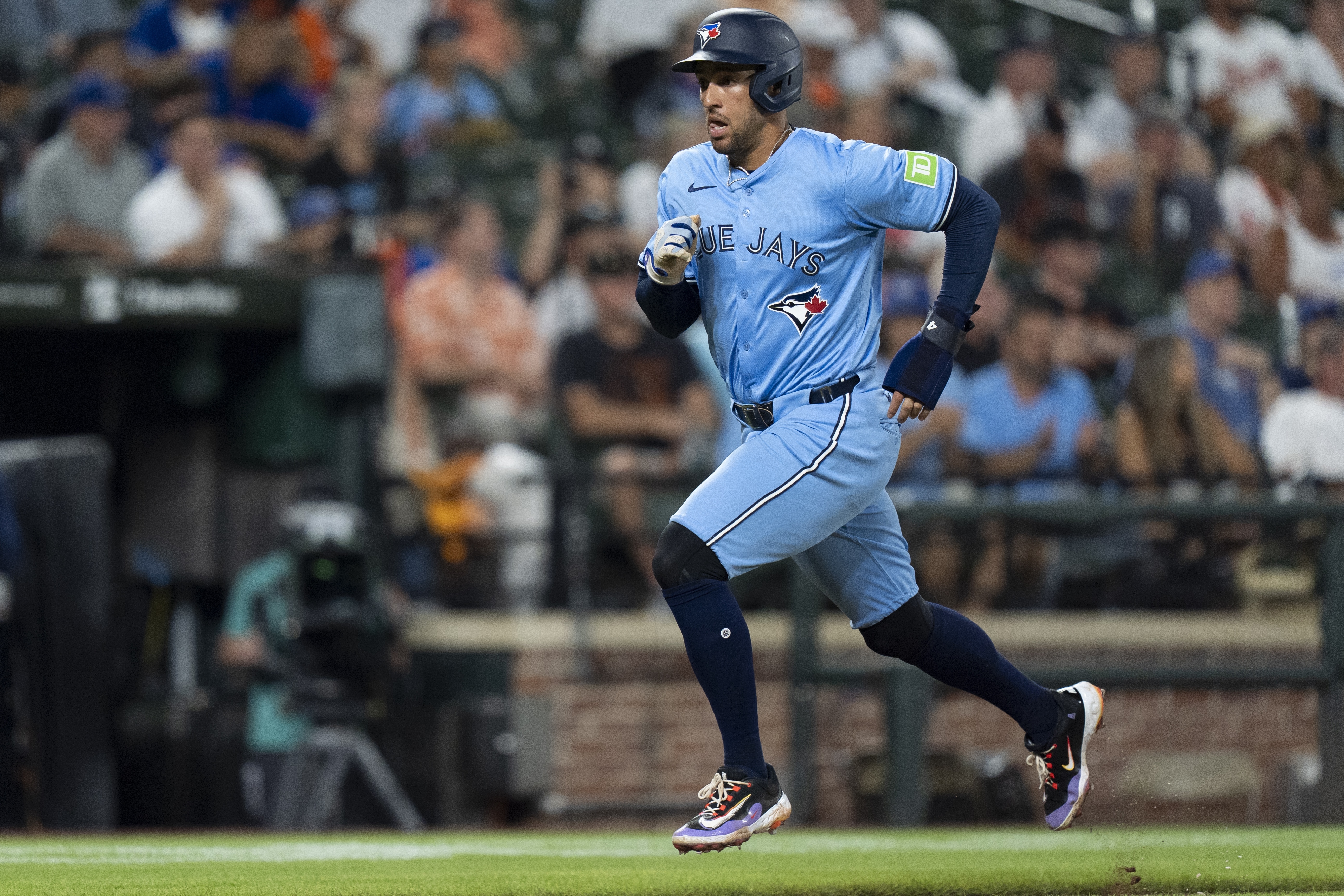 Toronto Blue Jays' George Springer advances toward home base to score on a sacrifice fly hit by Davis Schneider during the fourth inning in the second baseball game of a doubleheader against the Baltimore Orioles, Monday, July 29, 2024, in Baltimore.