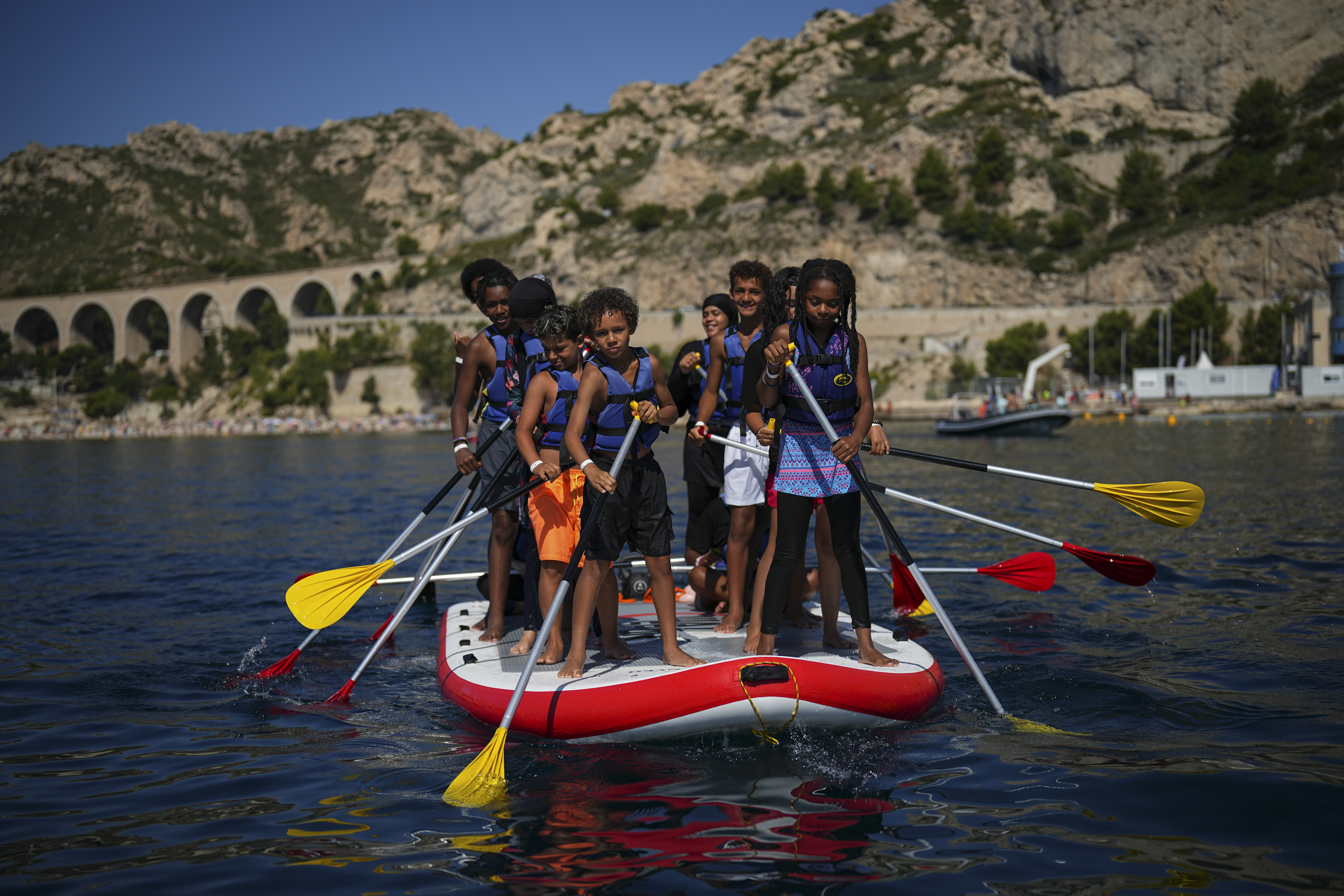 Children attend a swimming camp organized by the Grand Bleu Association which facilitates access to the sea for marginalized children in Marseille, France, Friday, July 26, 2024. Marseille, a millennia-old port, is a crossroads of cultures and faiths, where the sea is ever present but not equally accessible, and the beauty and cosmopolitan flair rub shoulders with enclaves of poverty and exclusion even more intimately than in the rest of France. 
