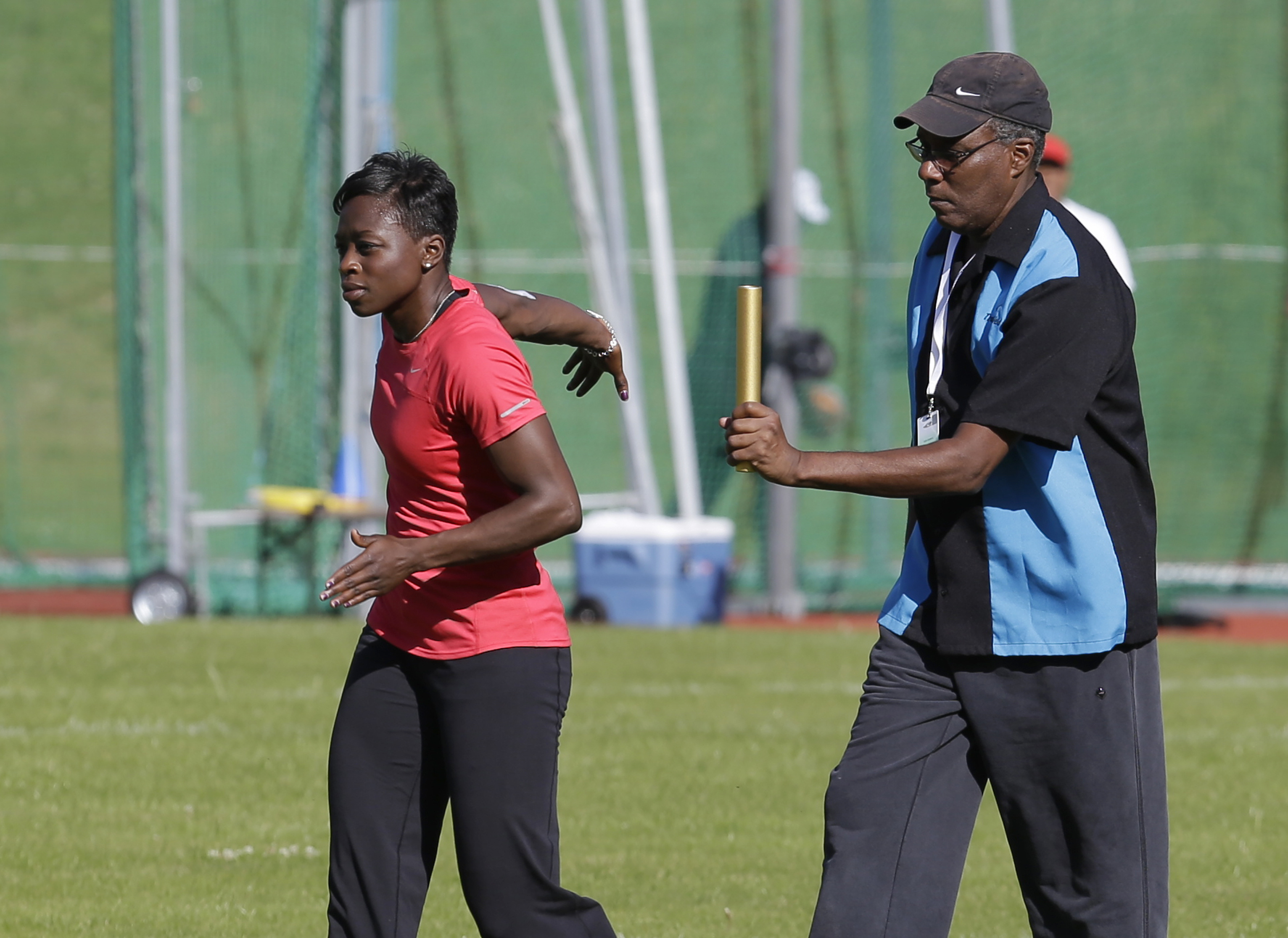 FILE - U.S. runner Jeneba Tarmoh, left, trains with her coach, Bobby Kersee for the 2012 Summer Olympics, Monday, July 23, 2012, in Birmingham, England. Kersee's known as the “mad scientist” for his outside-the-box training methods. He's concocted a winning formula that’s struck gold for some of the biggest stars in track history. 