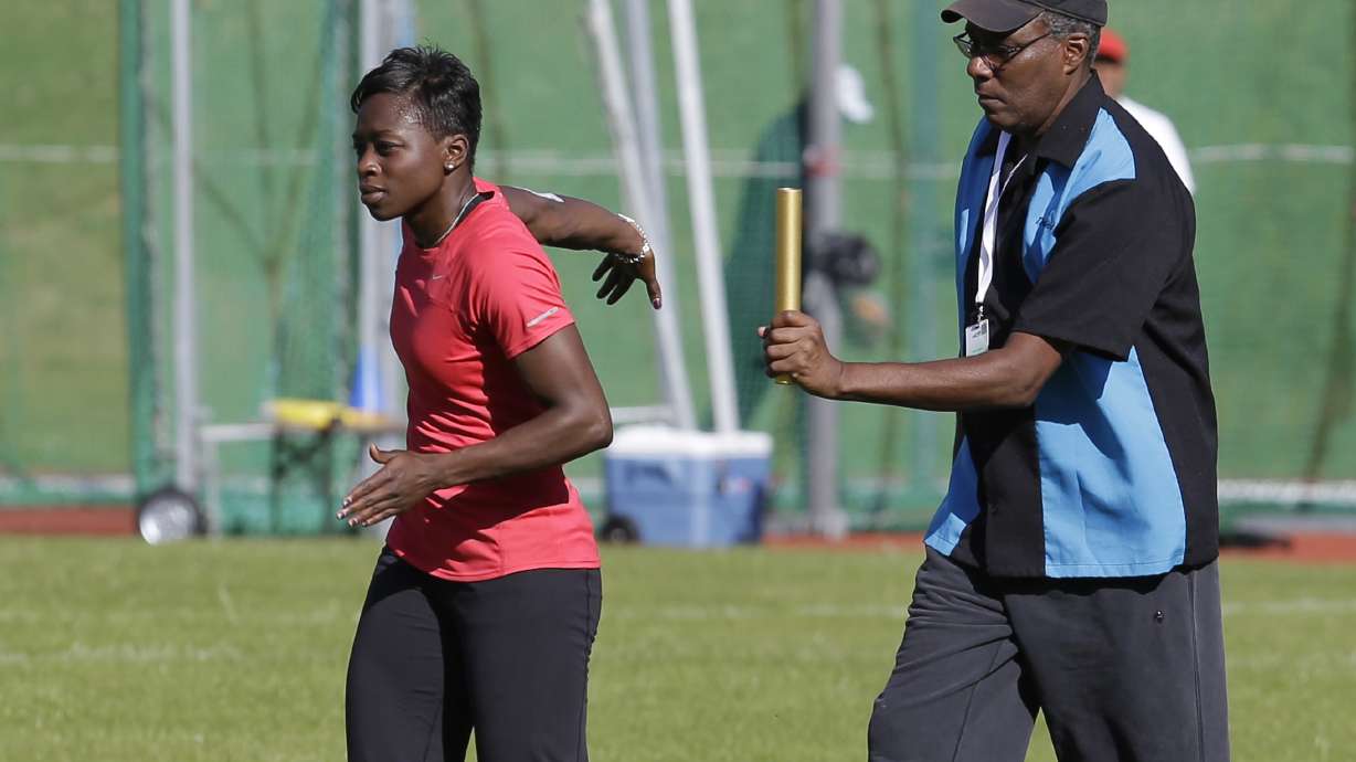 FILE - U.S. runner Jeneba Tarmoh, left, trains with her coach, Bobby Kersee for the 2012 Summer Olympics, Monday, July 23, 2012, in Birmingham, England. Kersee's known as the “mad scientist” for his outside-the-box training methods. He's concocted a winning formula that’s struck gold for some of the biggest stars in track history.