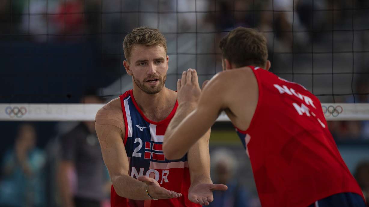 Norway's Christian Sandlie Soerum, left, and Anders Berntsen Mol react during the men's pool B beach volleyball match between Norway and Netherlands at Eiffel Tower Stadium at the 2024 Summer Olympics, Friday, Aug. 2, 2024, in Paris, France.