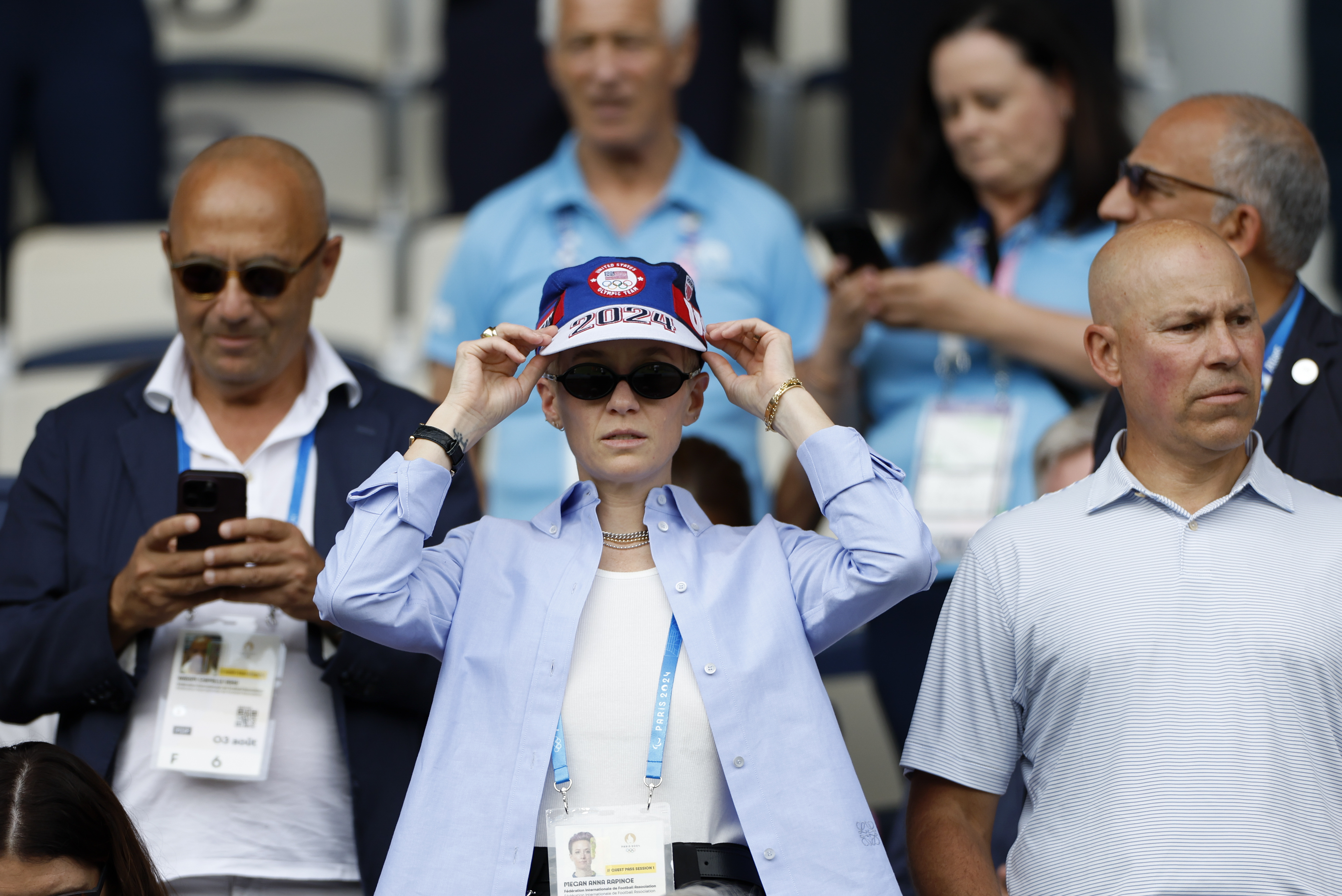 For US soccer player Megan Rapinoe adjusts her cap as she waits for the start of the quarterfinal women's soccer match between the United States and the Japan at the Parc des Princes at the 2024 Summer Olympics, Saturday, Aug. 3, 2024, in Paris, France.
