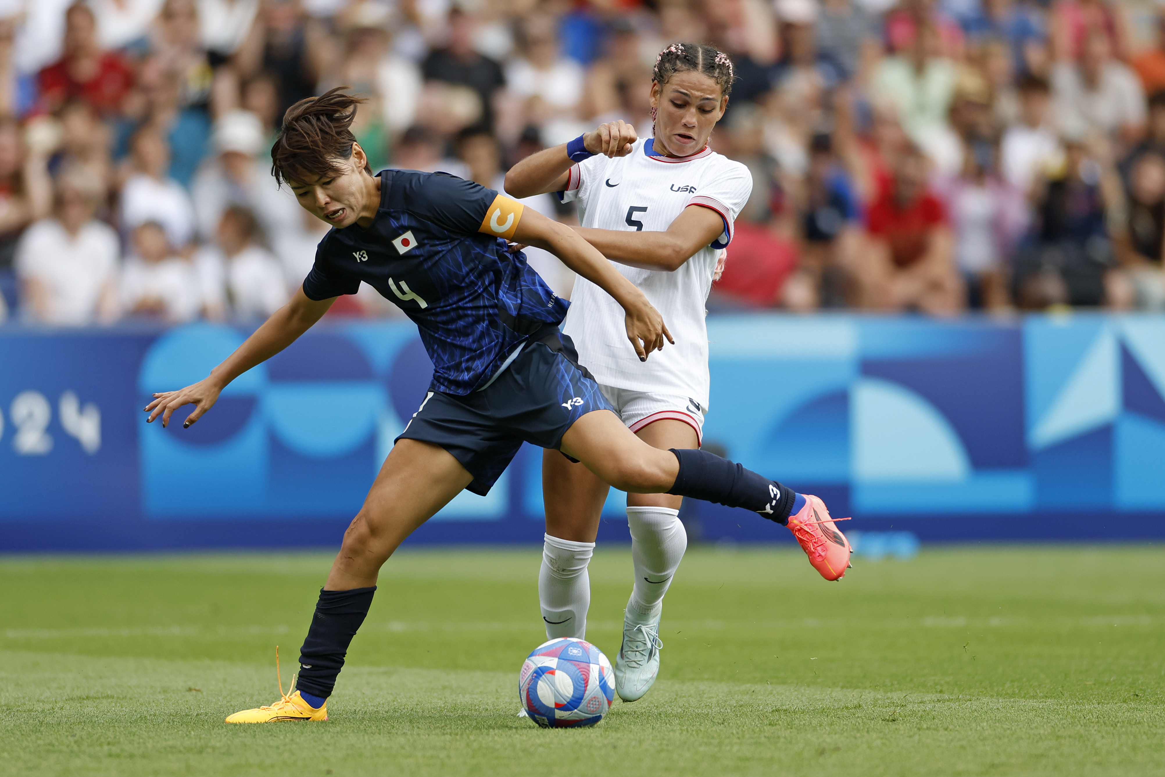 Japan's Saki Kumagai holds off Trinity Rodman of the United States during the quarterfinal women's soccer match between the United States and the Japan at the Parc des Princes at the 2024 Summer Olympics, Saturday, Aug. 3, 2024, in Paris, France.