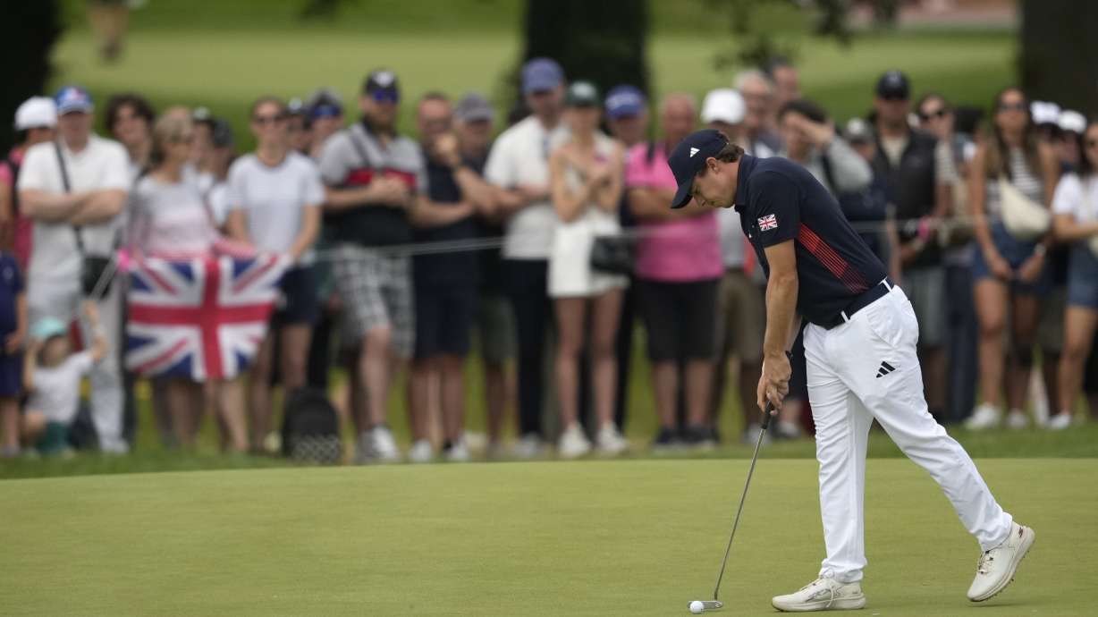 Matthew Fitzpatrick, of Britain taps in on the 5th green during the third round of the men's golf event at the 2024 Summer Olympics, Saturday, Aug. 3, 2024, at Le Golf National in Saint-Quentin-en-Yvelines, France.