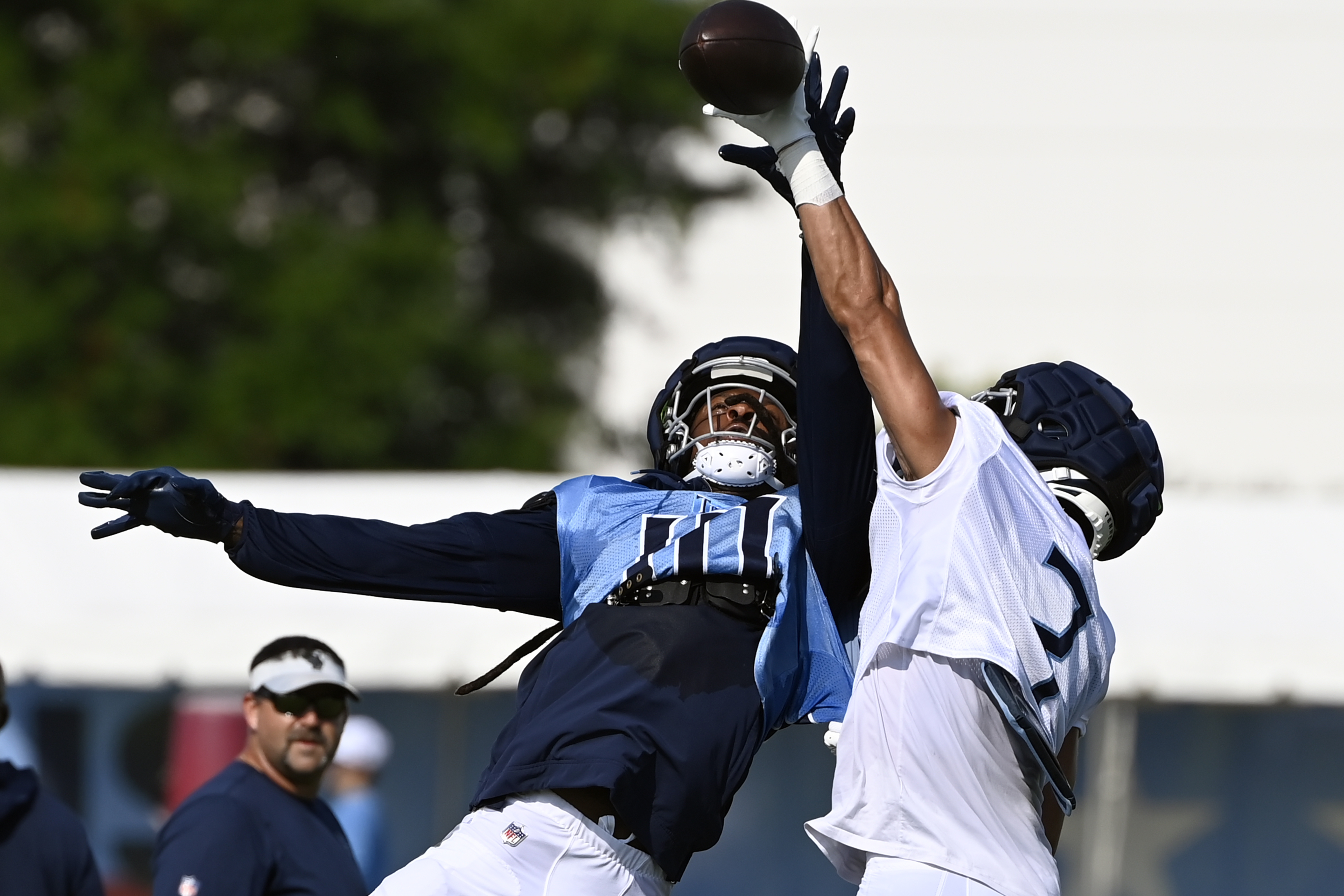 Tennessee Titans cornerback Caleb Farley, right, breaks up a pass intended for wide receiver DeAndre Hopkins (10) during NFL football training camp, Tuesday, July, 30, 2024, in Nashville, Tenn. 
