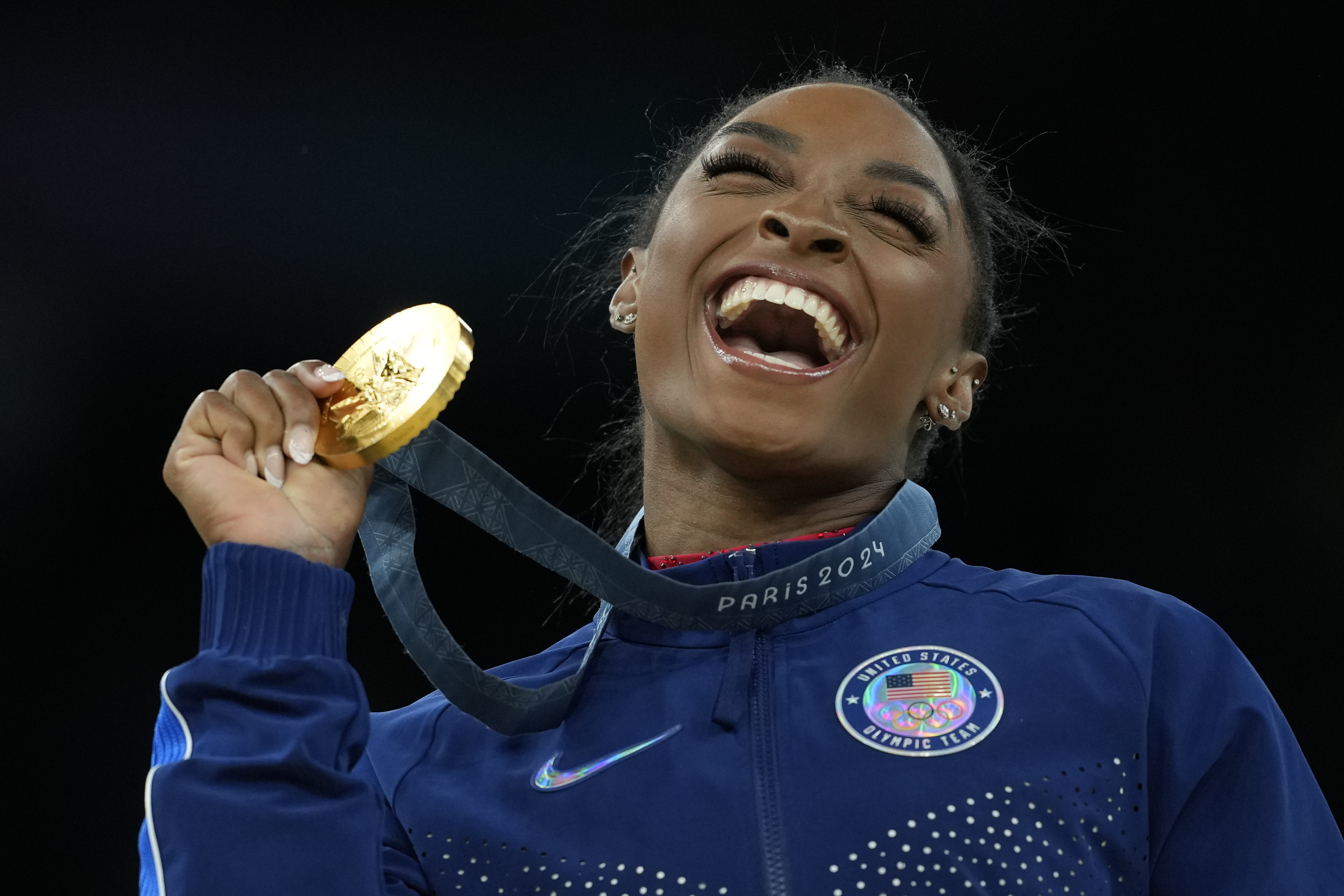 Simone Biles, of the United States, celebrates after winning the gold medal at the medal ceremony during the women's artistic gymnastics individual vault finals at Bercy Arena at the 2024 Summer Olympics, Saturday, Aug. 3, 2024, in Paris, France.