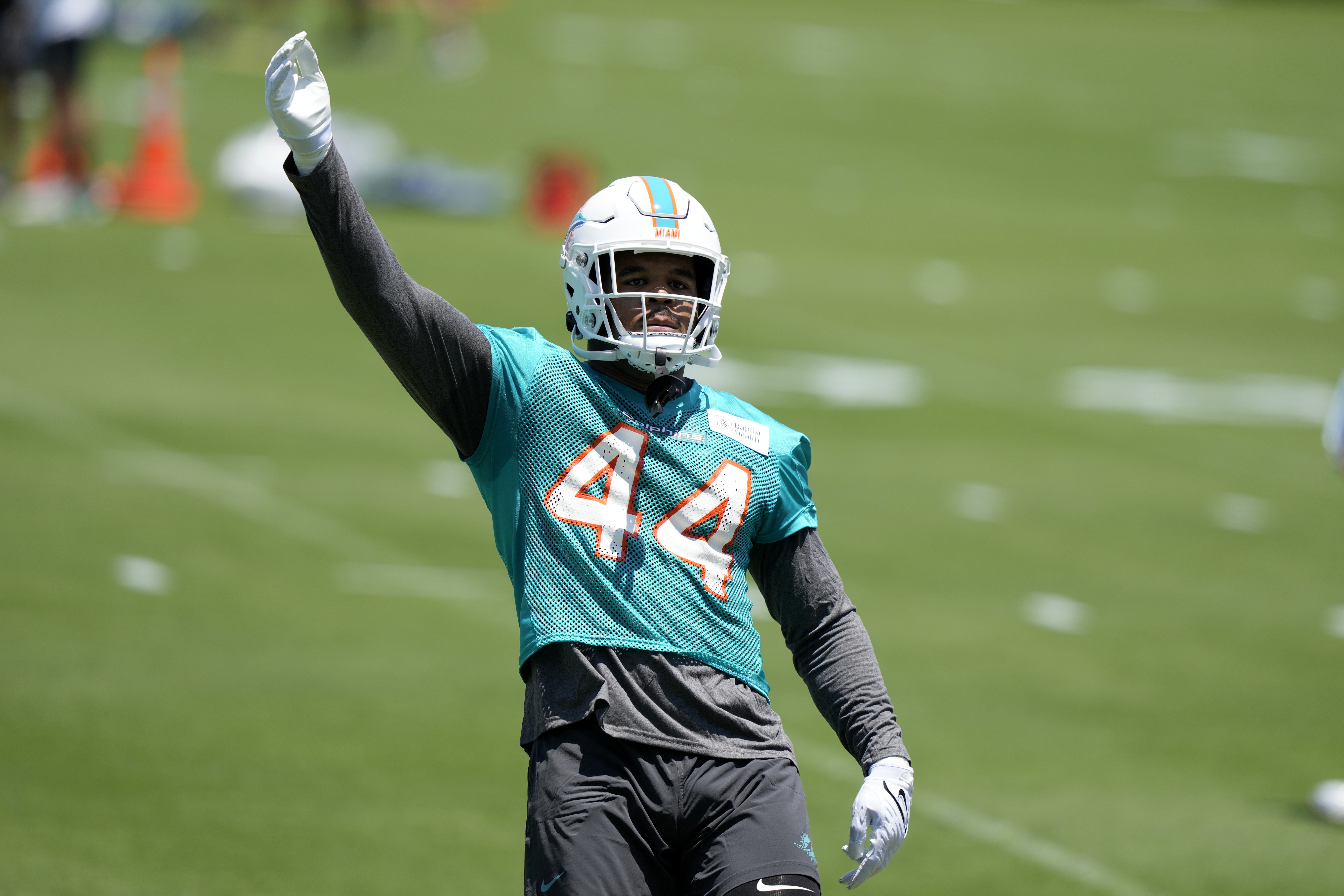 FILE - Linebacker Chop Robinson, selected by the Miami Dolphins in the first round of the NFL draft, stretches during the NFL football team's rookie minicamp May 10, 2024, in Miami Gardens, Fla.