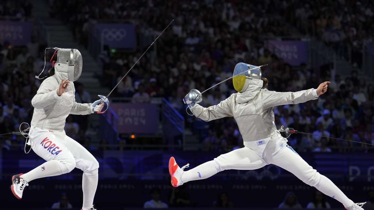 South Korea's Jeon Hayoung, left, competes with Ukraine's Alina Komashchuk in the women's team sabre final match during the 2024 Summer Olympics at the Grand Palais, Saturday, Aug. 3, 2024, in Paris, France.