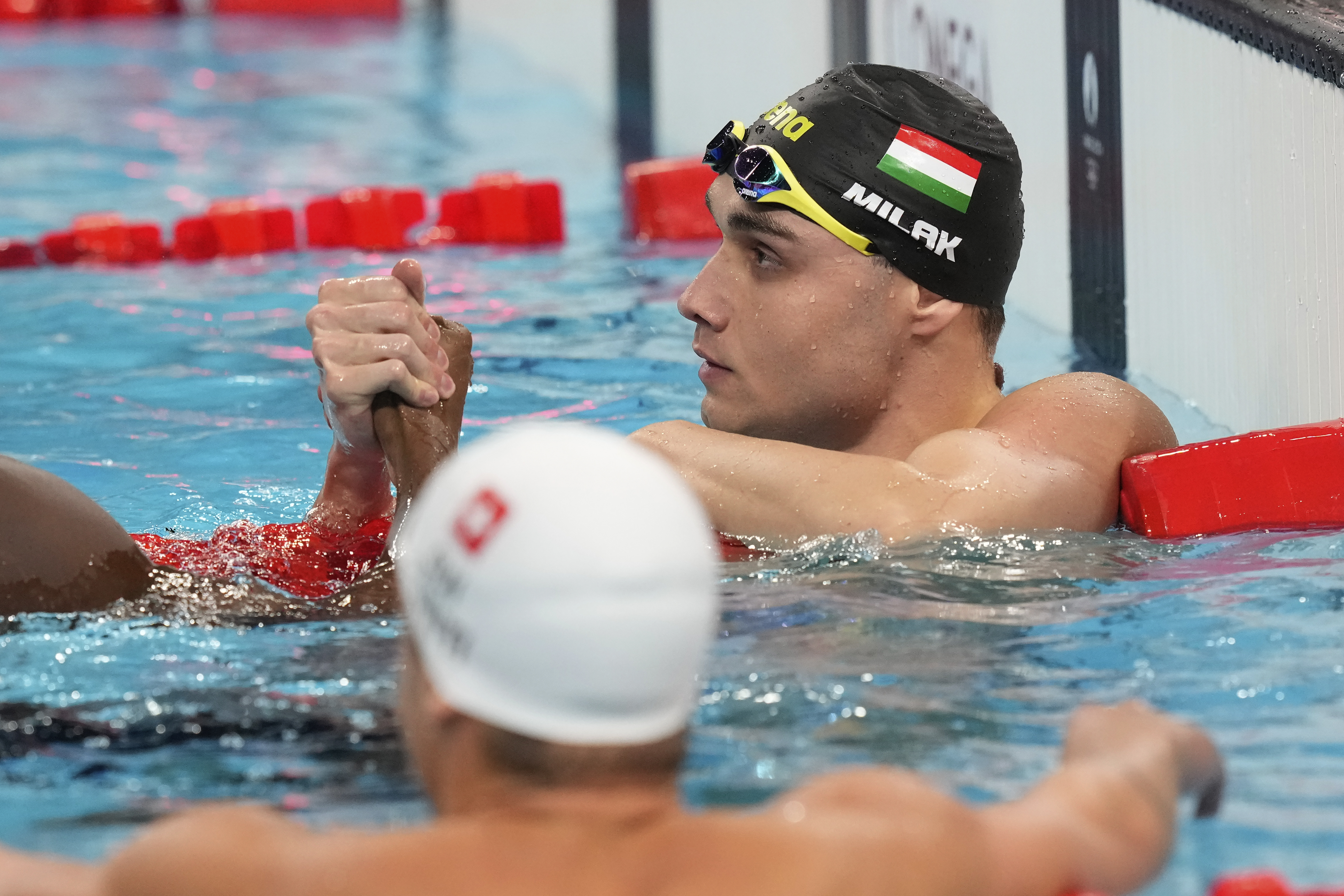 Hungary's Kristof Milak celebrates winning the gold medal in the men's 100-meter butterfly final at the Summer Olympics in Nanterre, France, Saturday, Aug. 3, 2024. 