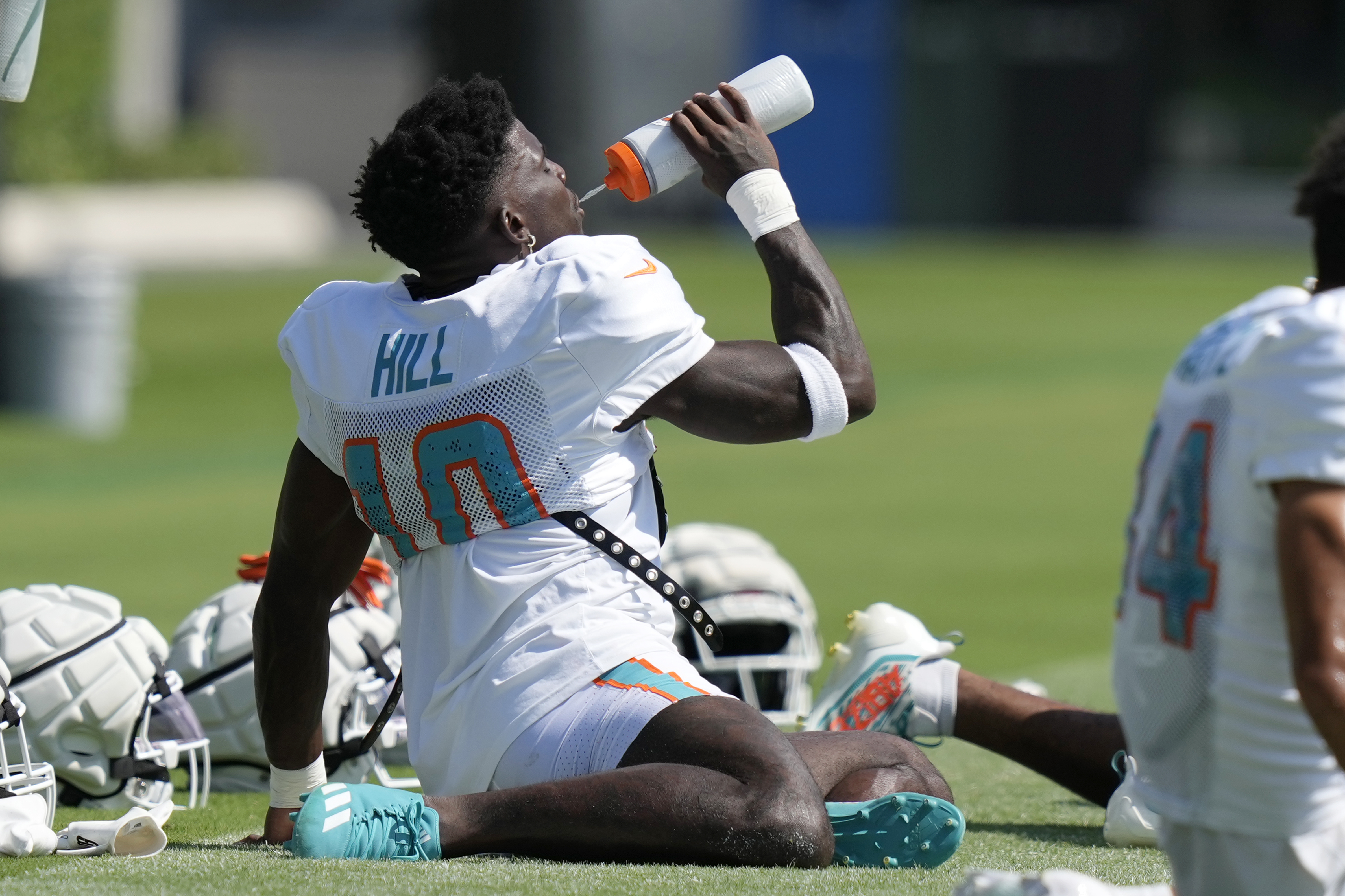 Miami Dolphins wide receiver Tyreek Hill (10) takes a drink during the NFL football team's training camp Monday, July 29, 2024, in Miami Gardens, Fla.