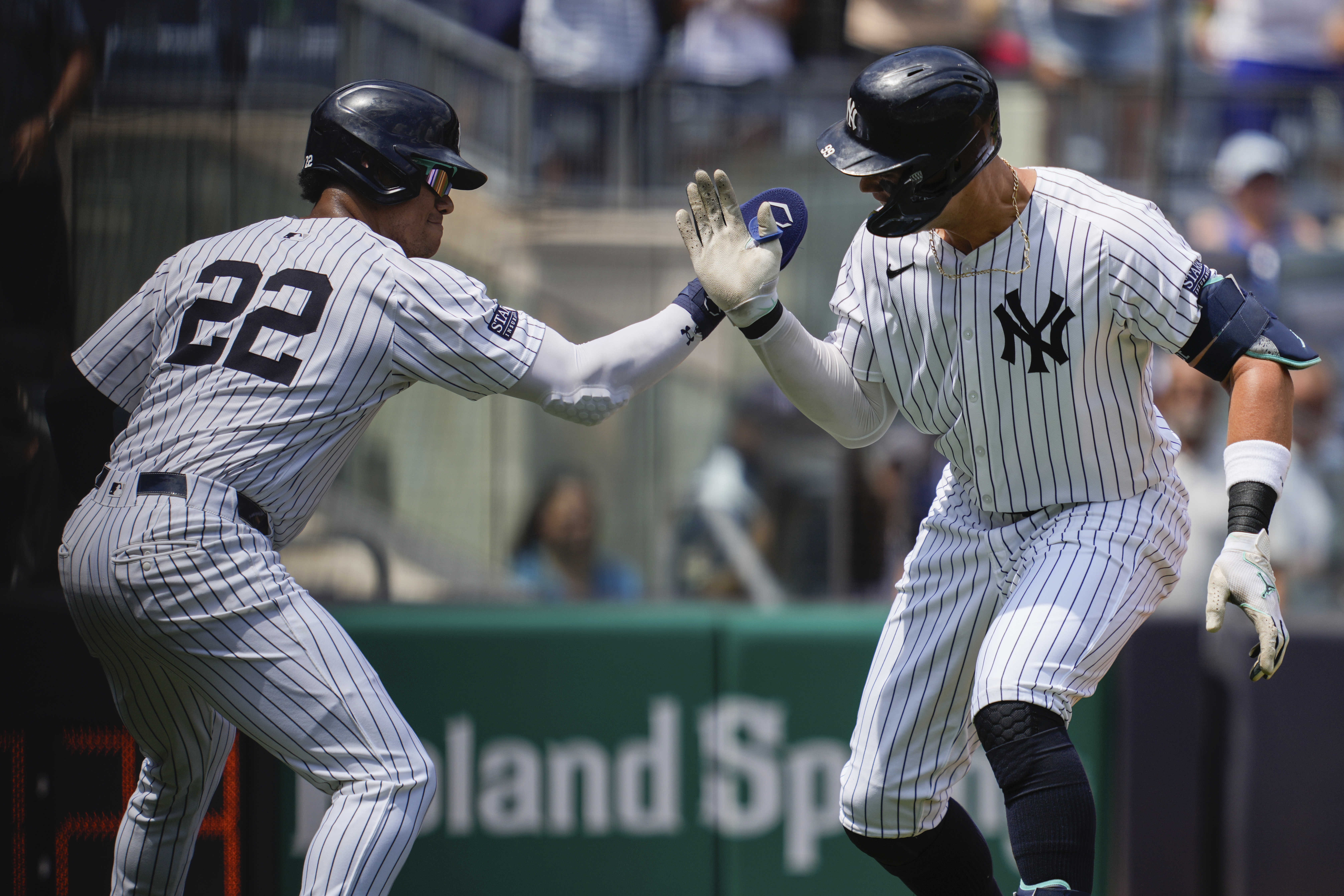 New York Yankees' Juan Soto (22) and Aaron Judge celebrate after Judge hit a two-run home run during the first inning of a baseball game against the Toronto Blue Jays, Saturday, Aug. 3, 2024, in New York.