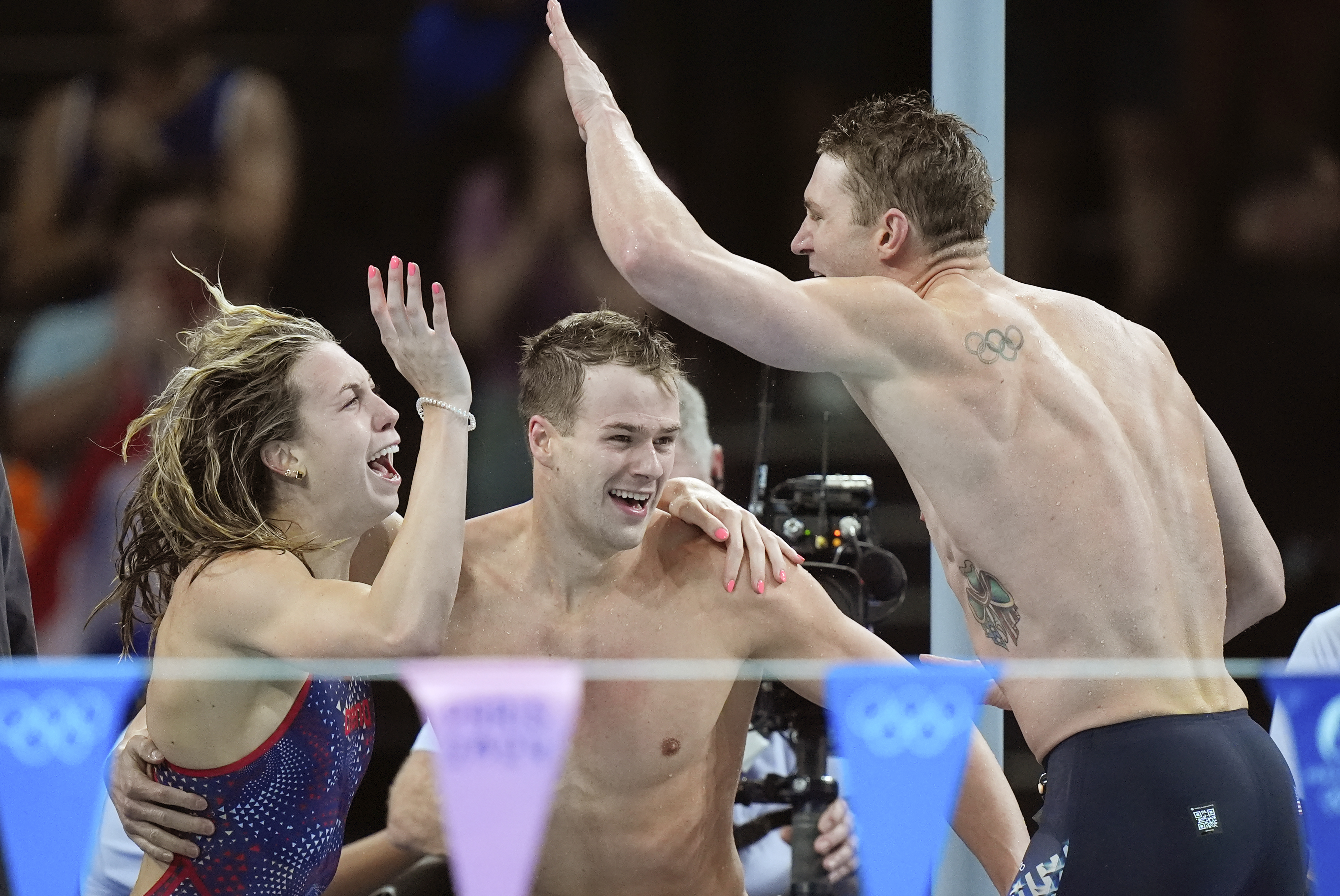 United States' team celebrates winning the gold medal in the mixed 4x100-meter medley relay final at the Summer Olympics in Nanterre, France, Saturday, Aug. 3, 2024. 