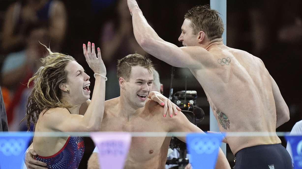 United States' team celebrates winning the gold medal in the mixed 4x100-meter medley relay final at the Summer Olympics in Nanterre, France, Saturday, Aug. 3, 2024.