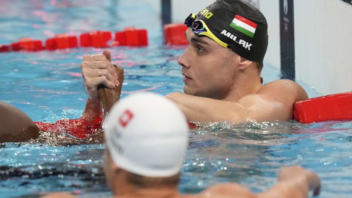 Hungary's Kristof Milak celebrates winning the gold medal in the men's 100-meter butterfly final at the Summer Olympics in Nanterre, France, Saturday, Aug. 3, 2024.