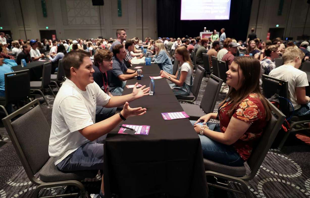 Isaac Farfan and Hannah Graham participate in speed dating at the 2024 Utah Area Young Single Adult Conference at the Salt Palace Convention Center in Salt Lake City on Friday.