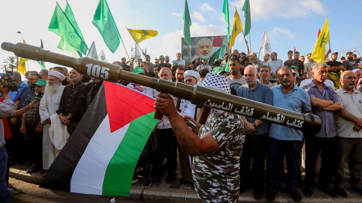 A supporter of the Lebanese Islamic group and the Islamist Hamas movement holds a mock rocket as he attends with other supporters a protest to condemn the killing of Hamas political chief Ismail Haniyeh, Wednesday in the southern port city of Sidon, Lebanon. Haniyeh was killed in an airstrike in the Iranian capital early Wednesday.