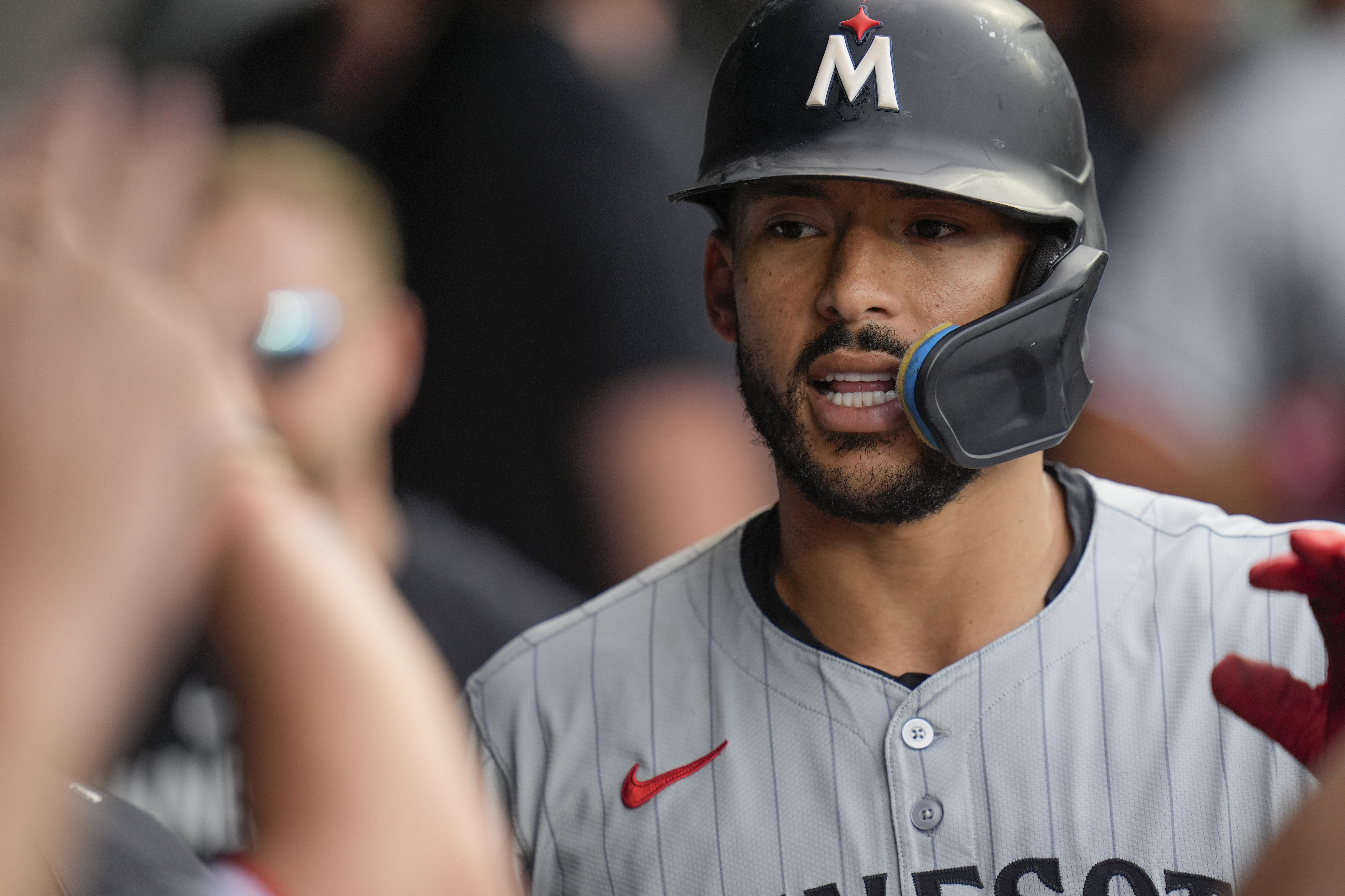 Minnesota Twins' Carlos Correa celebrates in the dugout after hitting a home run during the sixth inning of the second baseball game of a doubleheader against the Chicago White Sox, Wednesday, July 10, 2024, in Chicago.