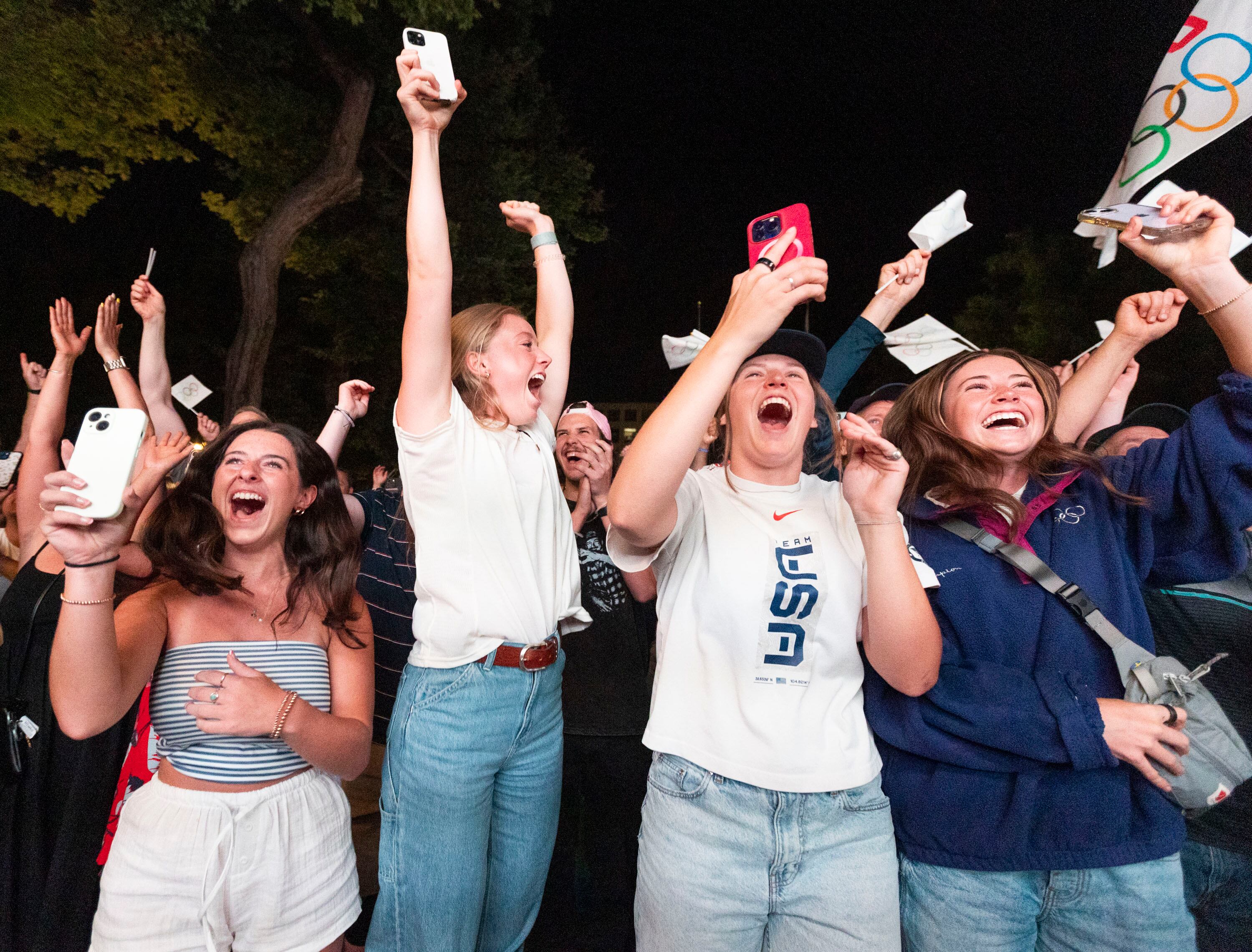 Jillian Highfill, 20, left, Sami Worthington, 20, center left, Hanna Faulhaber,19, center right, and Izzy Worthington,17, right, all cheer after the IOC awarded the 2034 Winter Olympic Games to the Salt Lake City-Utah Committee July 24.