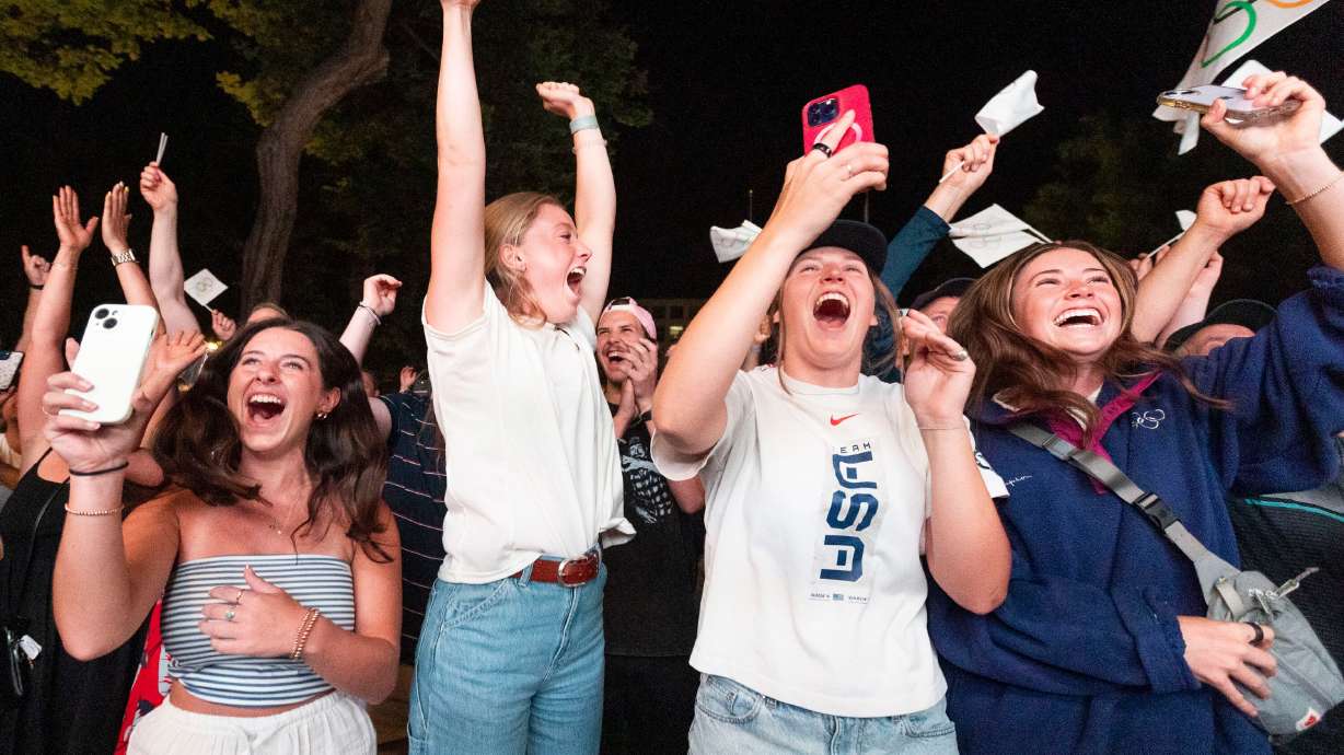 Jillian Highfill, 20, left, Sami Worthington, 20, center left, Hanna Faulhaber,19, center right, and Izzy Worthington,17, right, all cheer after the IOC awarded the 2034 Winter Olympic Games to the Salt Lake City-Utah Committee July 24.