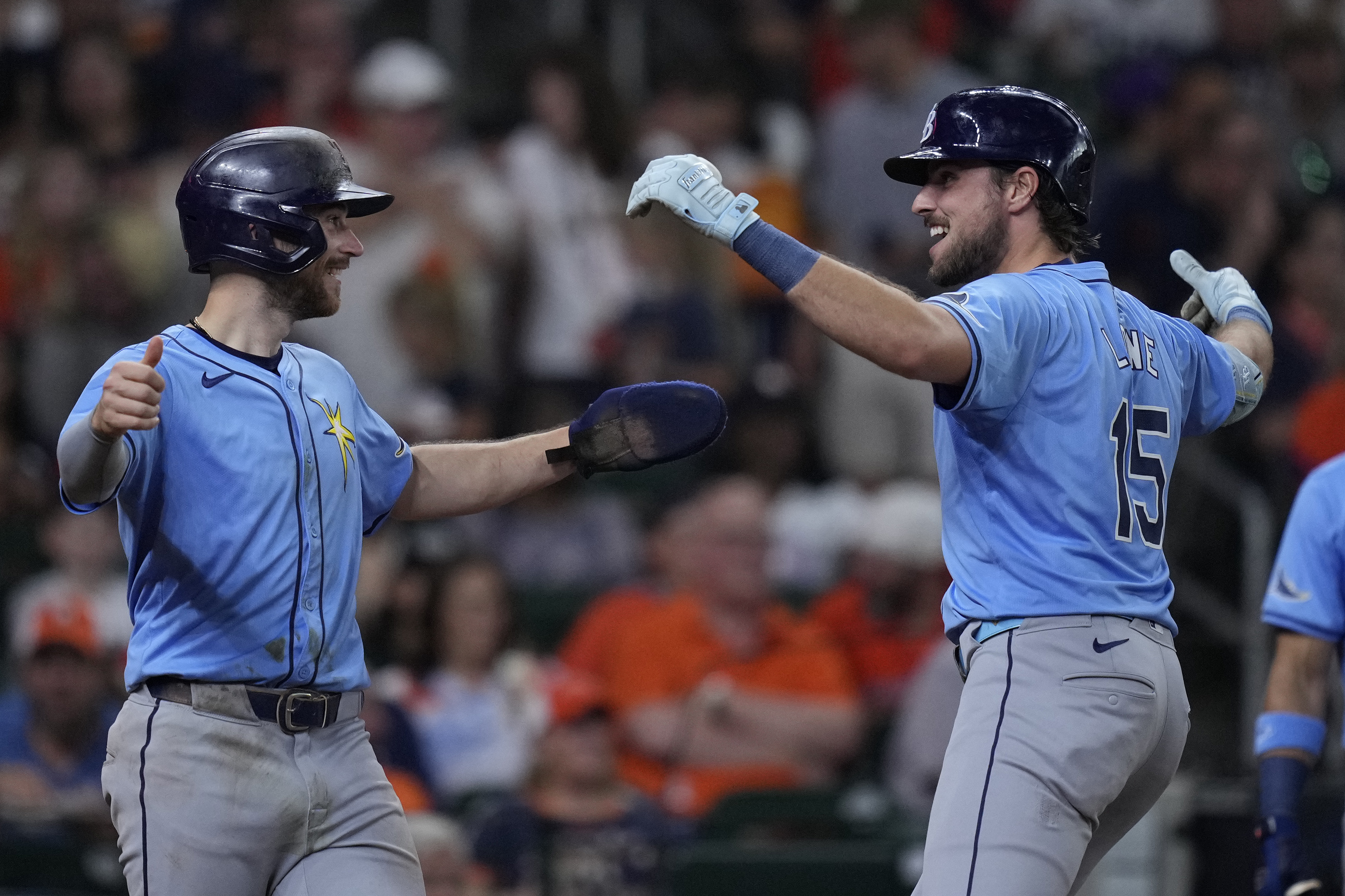 Tampa Bay Rays' Josh Lowe, right, celebrates with Brandon Lowe, left after hitting a two-run home run during the fifth inning of a baseball game against the Houston Astros, Saturday, Aug. 3, 2024, in Houston. 