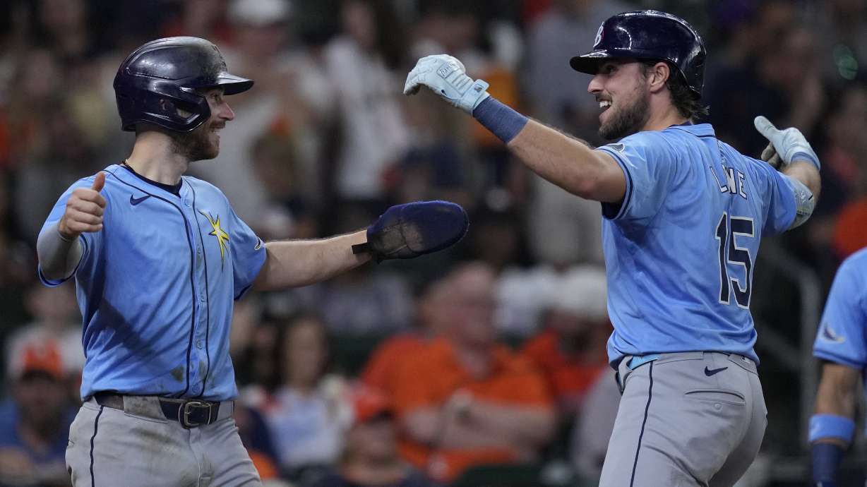 Tampa Bay Rays' Josh Lowe, right, celebrates with Brandon Lowe, left after hitting a two-run home run during the fifth inning of a baseball game against the Houston Astros, Saturday, Aug. 3, 2024, in Houston.