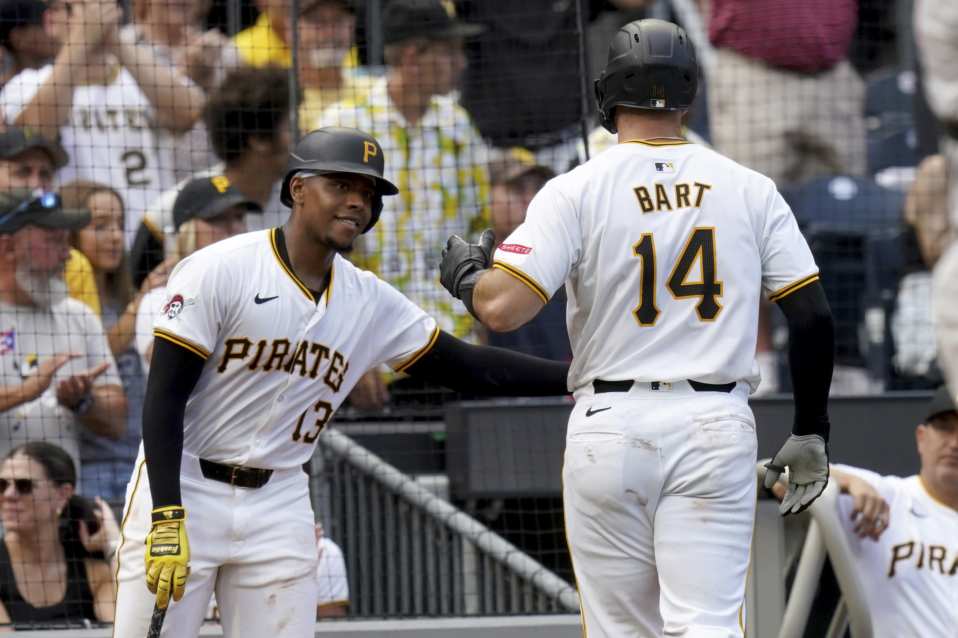 Pittsburgh Pirates' Joey Bart, right, is greeted by Ke'Bryan Hayes, left, after hitting a home run during the second inning of a baseball game against the Arizona Diamondbacks, Saturday, Aug. 3, 2024, in Pittsburgh. 
