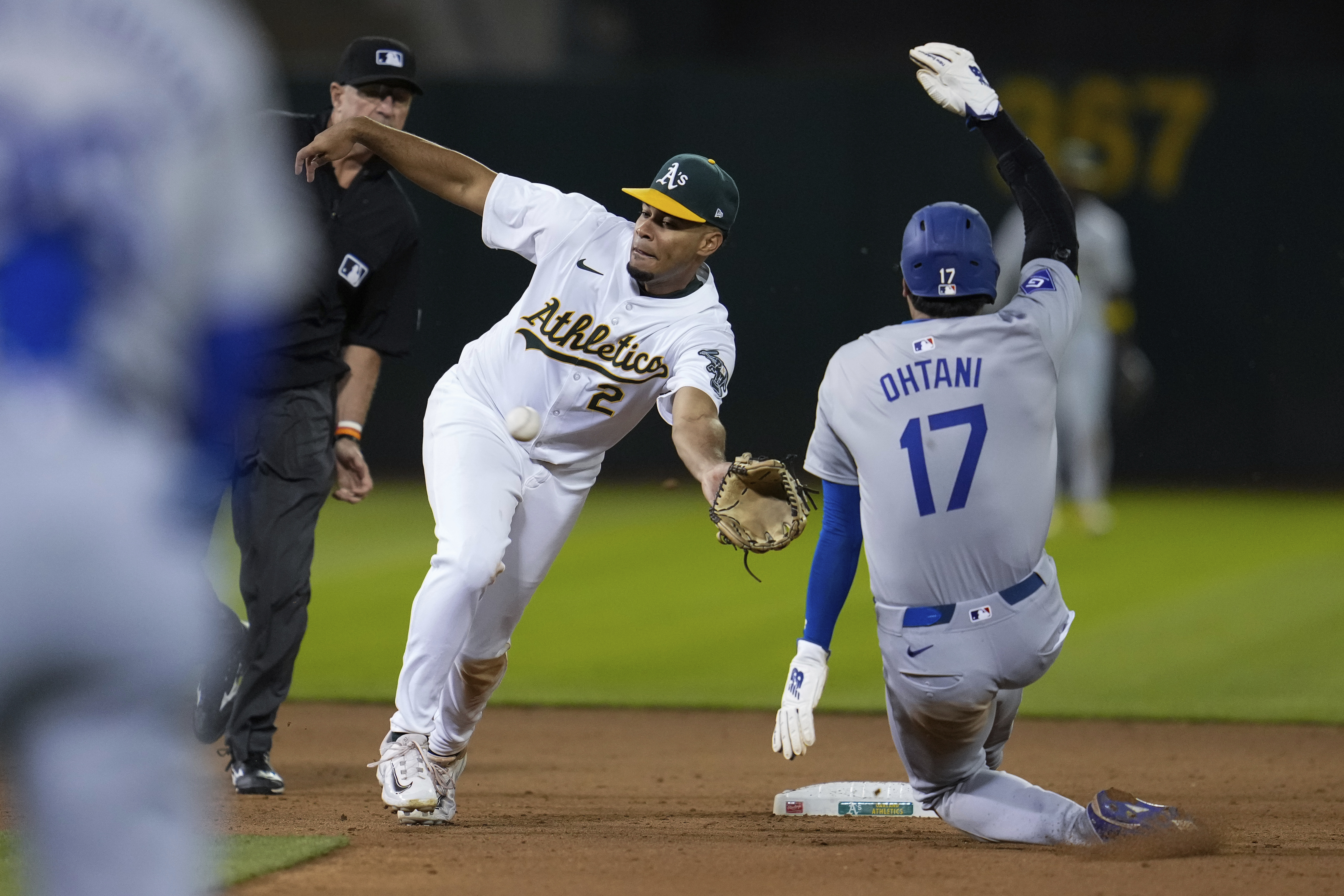 Oakland Athletics second baseman Darell Hernaiz (2) is unable to catch a throw from catcher Shea Langeliers as Los Angeles Dodgers' Shohei Ohtani (17) steals second during the ninth inning of a baseball game Saturday, Aug. 3, 2024, in Oakland, Calif. 