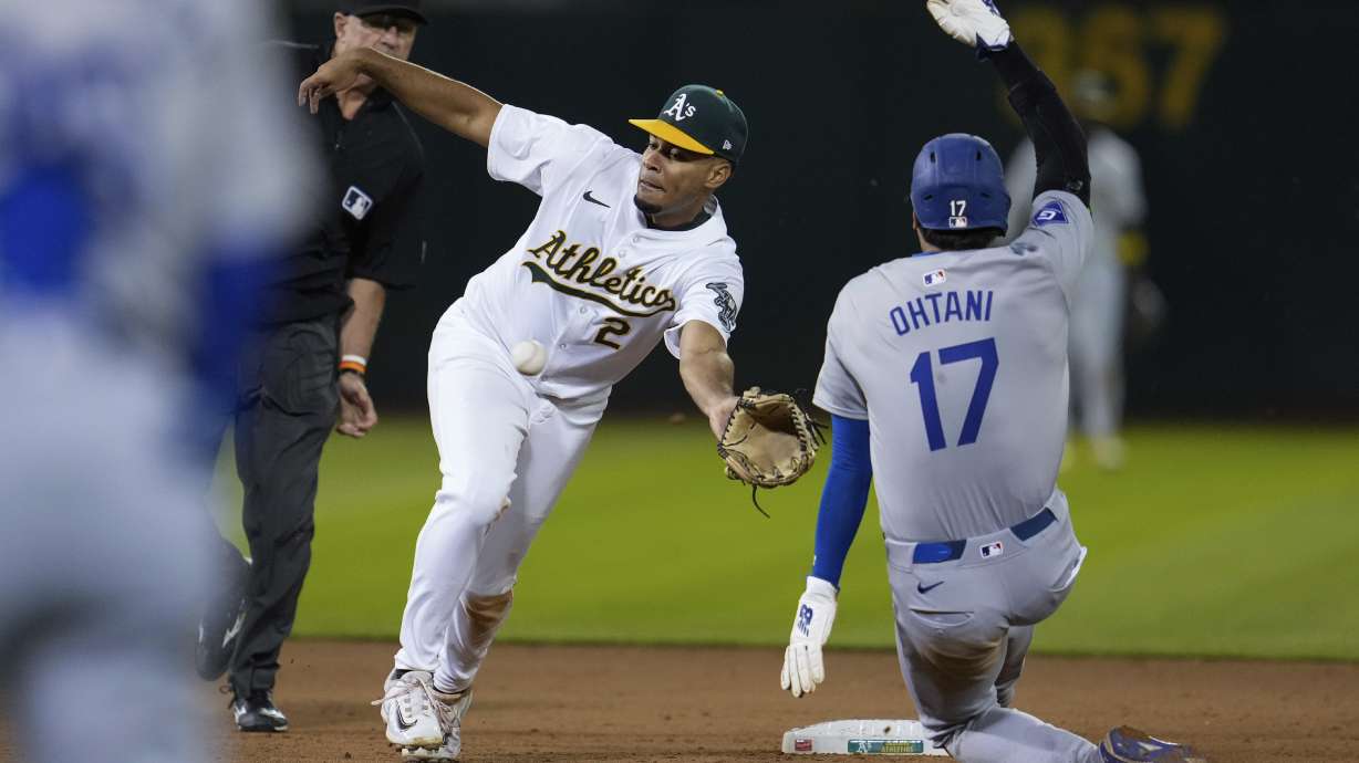 Oakland Athletics second baseman Darell Hernaiz (2) is unable to catch a throw from catcher Shea Langeliers as Los Angeles Dodgers' Shohei Ohtani (17) steals second during the ninth inning of a baseball game Saturday, Aug. 3, 2024, in Oakland, Calif.