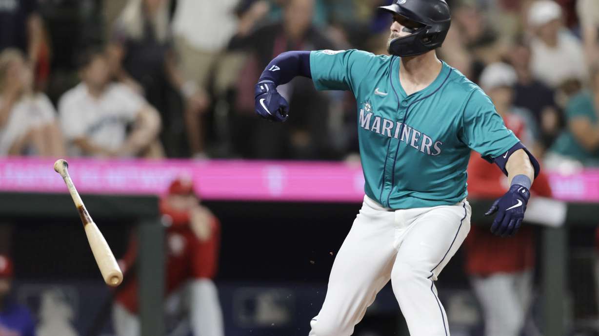 Seattle Mariners' Mitch Haniger reacts after drawing a walk-off walk to win 6-5 during the 10th inning against the Philadelphia Phillies in a baseball game Saturday, Aug. 3, 2024, in Seattle.