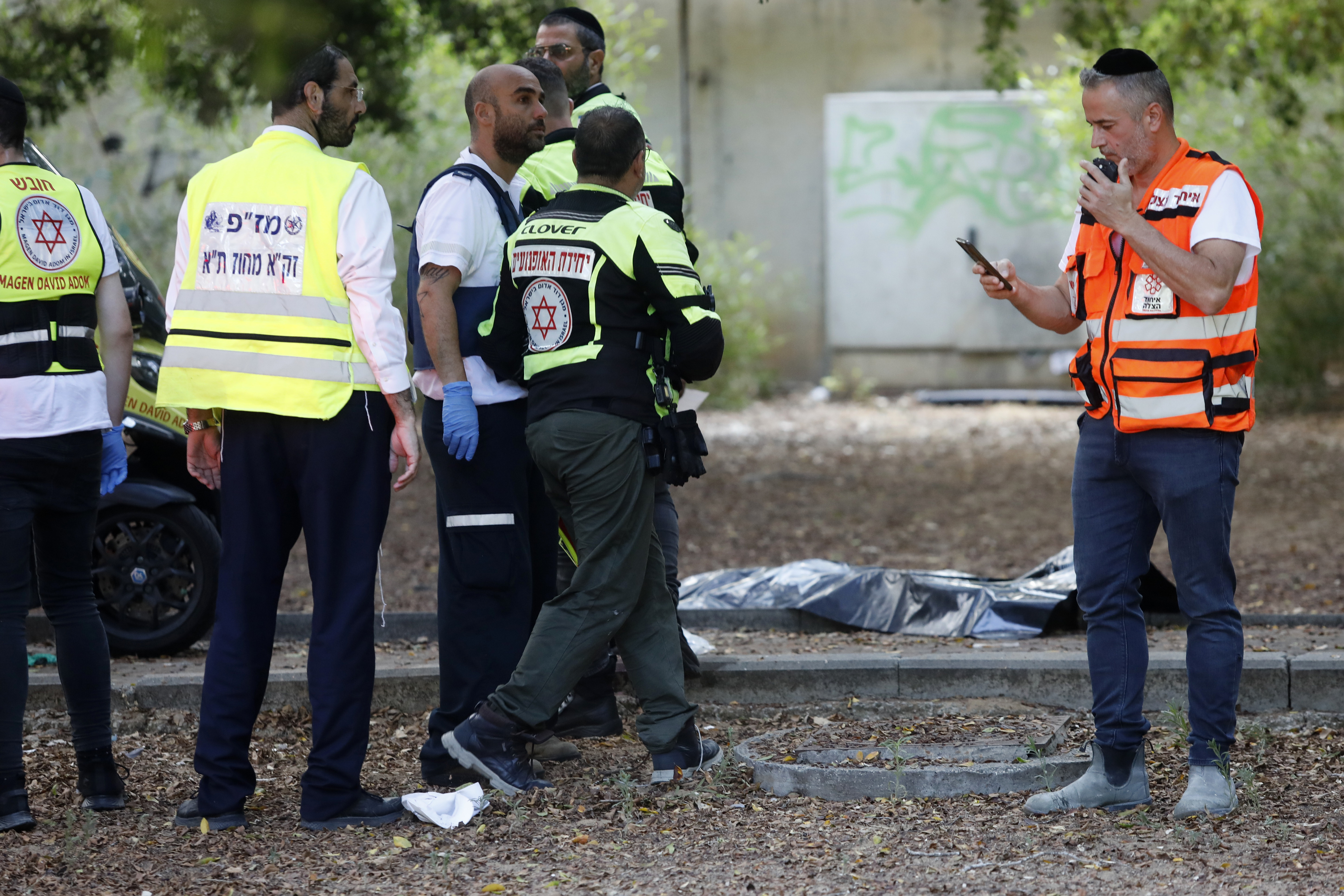 First responders work at the site of a stabbing attack that, Israeli police said, a Palestinian attacked killed a woman and wounded a few others in Holon, Israel Sunday.