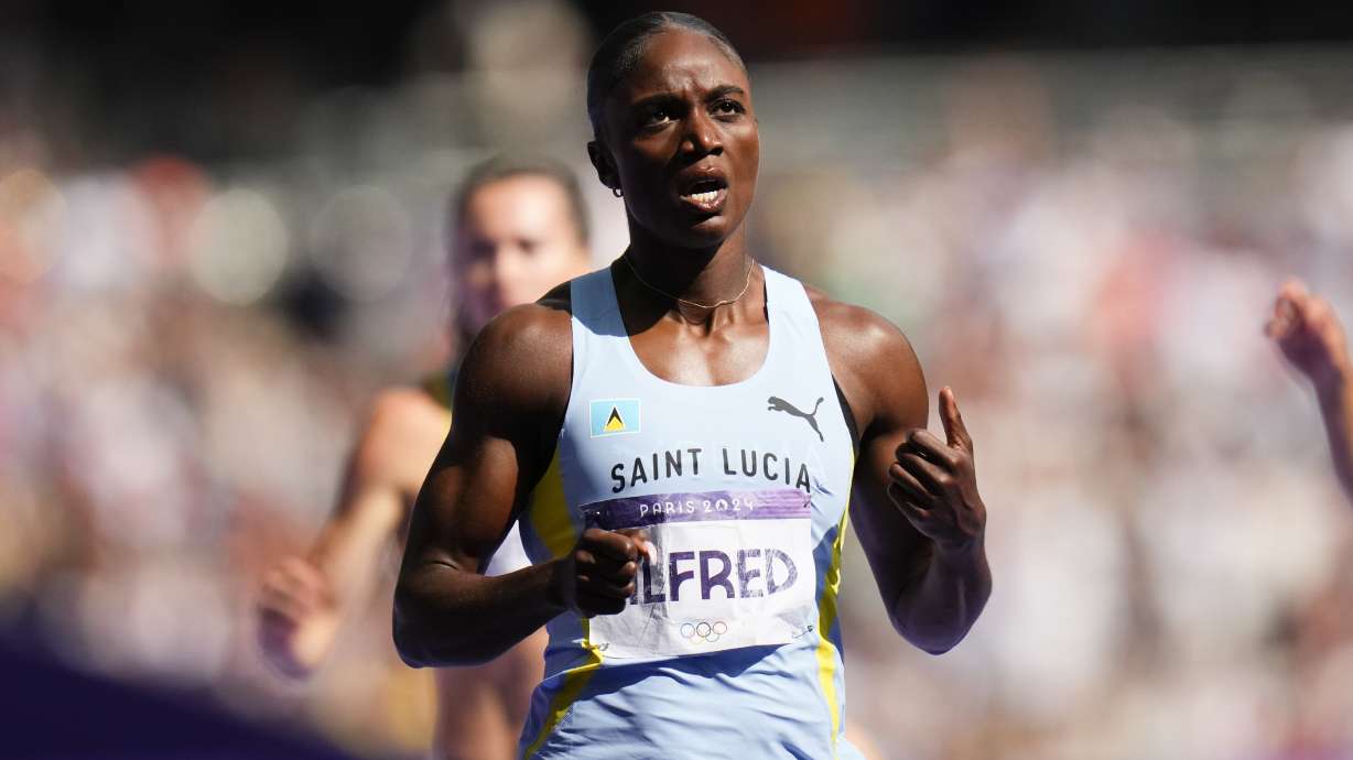 Julien Alfred, of Saint Lucia, wins a heat in the women's 200-meter at the 2024 Summer Olympics, Sunday, Aug. 4, 2024, in Saint-Denis, France.