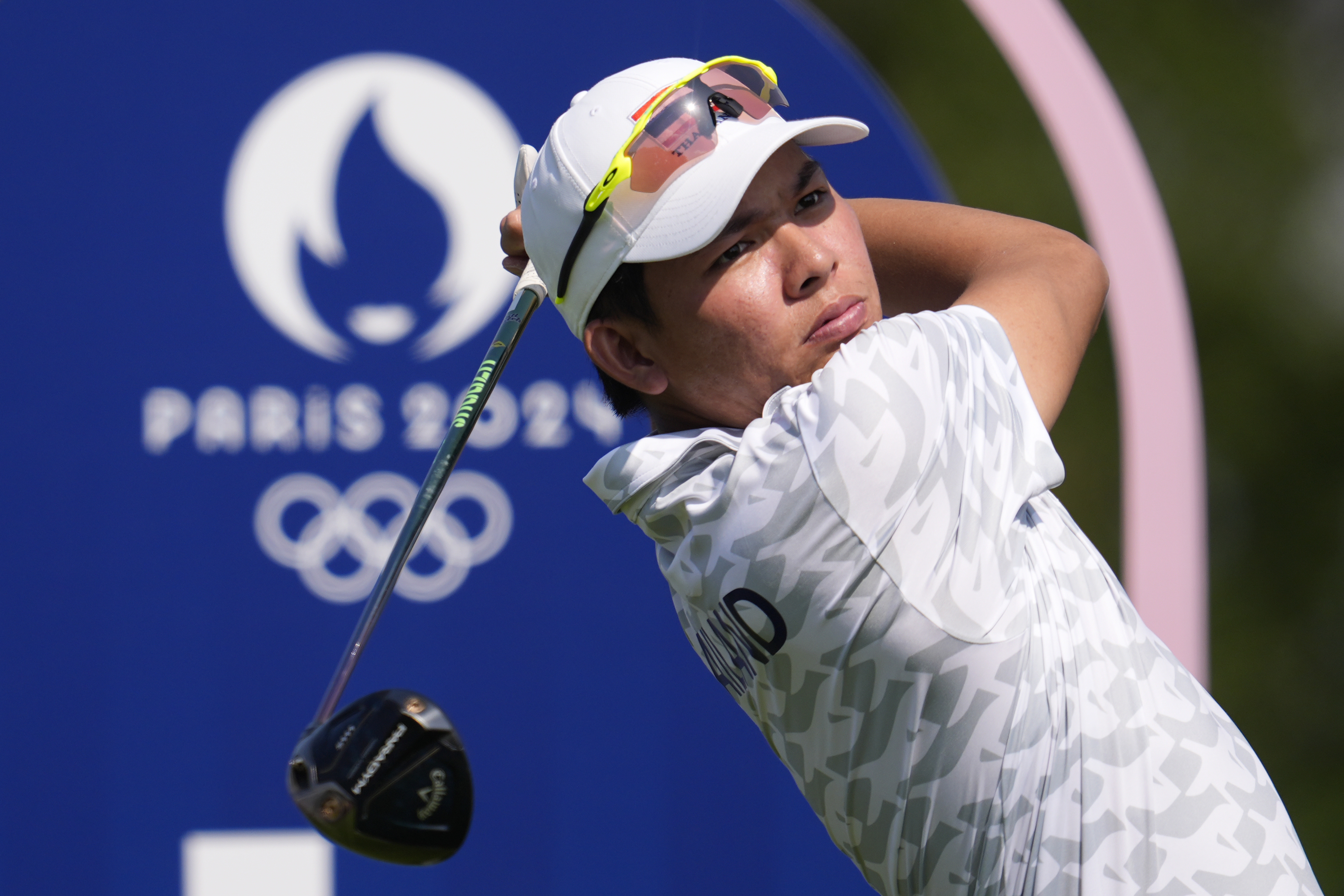 Phachara Khongwatmai, of Thailand, plays his tee shot on the 4th hole during the first round of the men's golf event at the 2024 Summer Olympics, Thursday, Aug. 1, 2024, at Le Golf National in Saint-Quentin-en-Yvelines, France. 