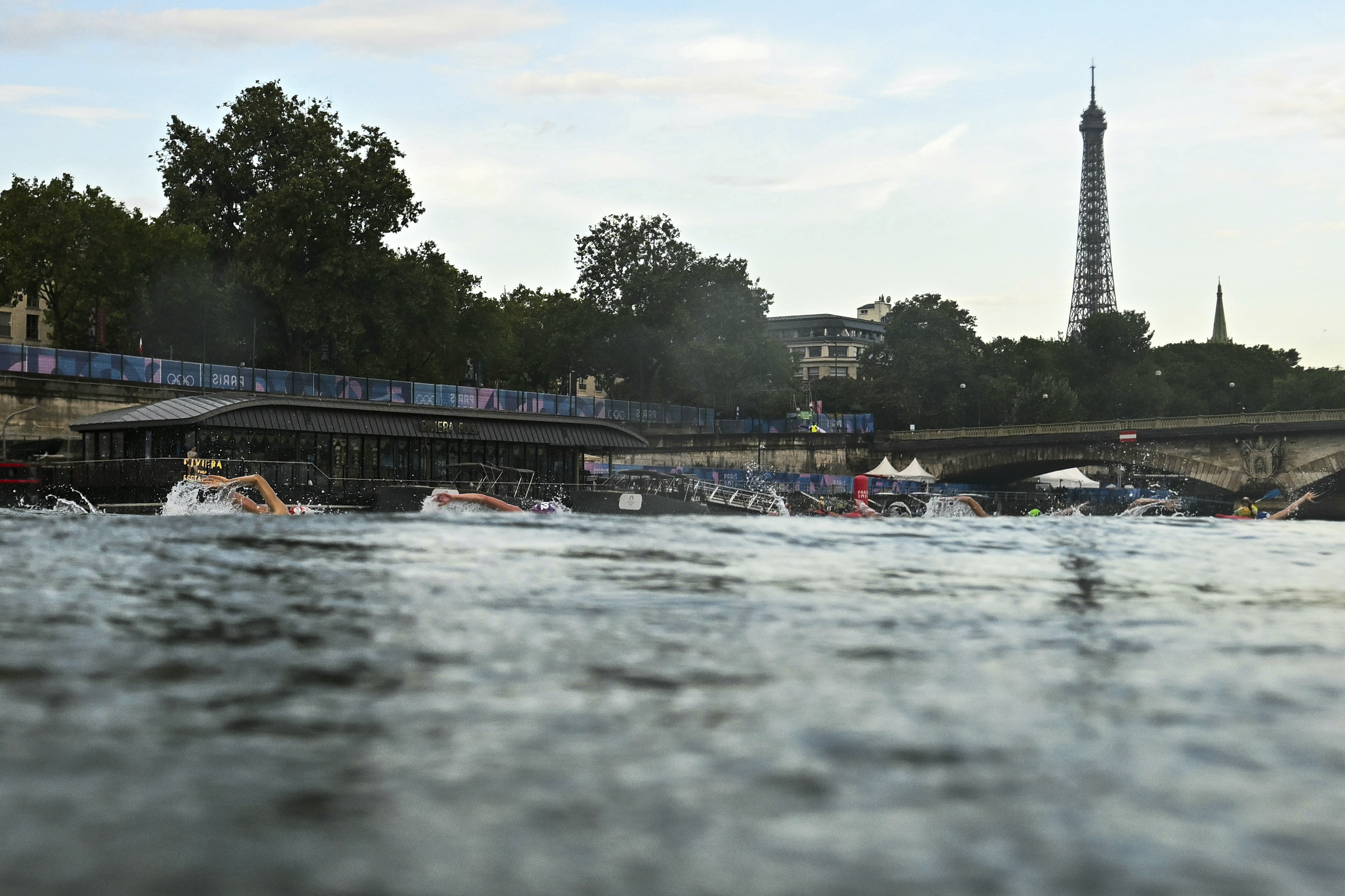Athletes compete in the swimming race in the Seine River during the women's individual triathlon at the 2024 Summer Olympics, Wednesday, July 31, 2024, in Paris, France. 