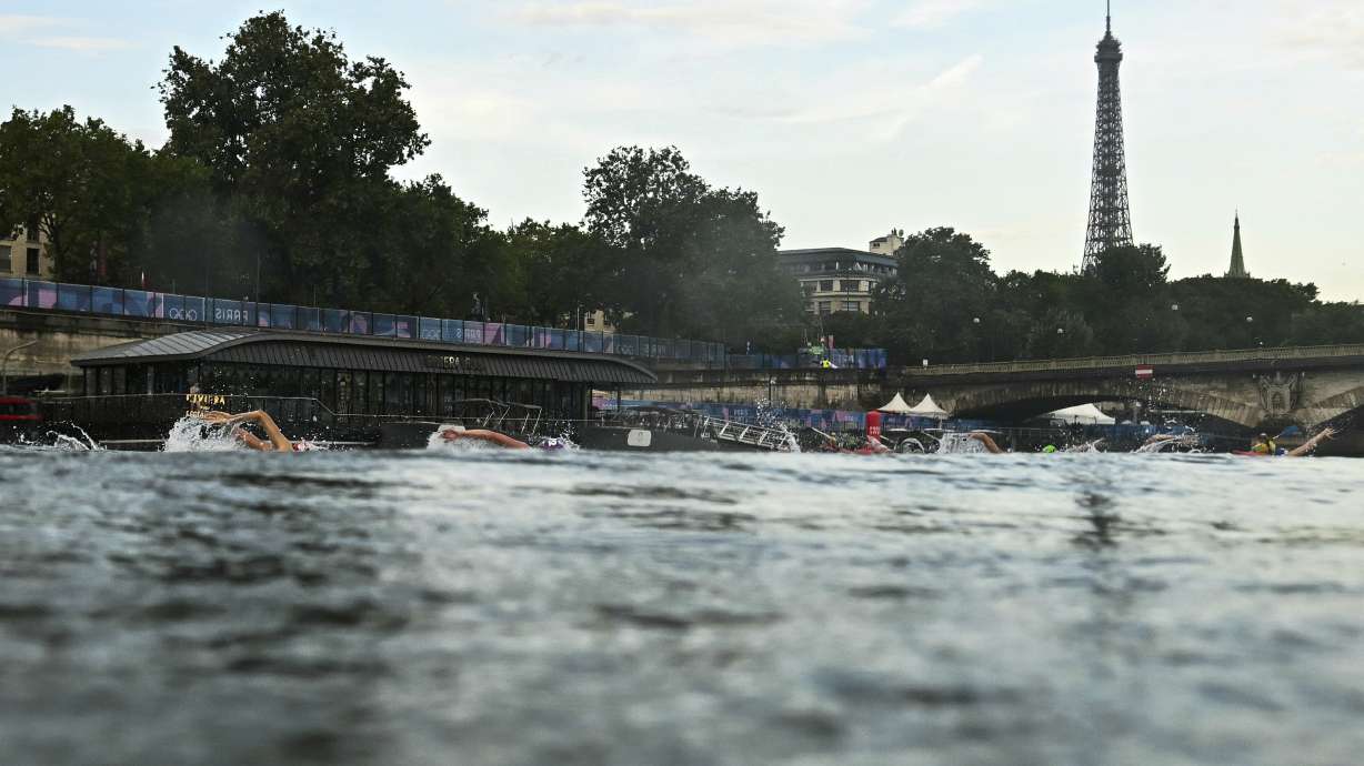 Athletes compete in the swimming race in the Seine River during the women's individual triathlon at the 2024 Summer Olympics, Wednesday, July 31, 2024, in Paris, France.