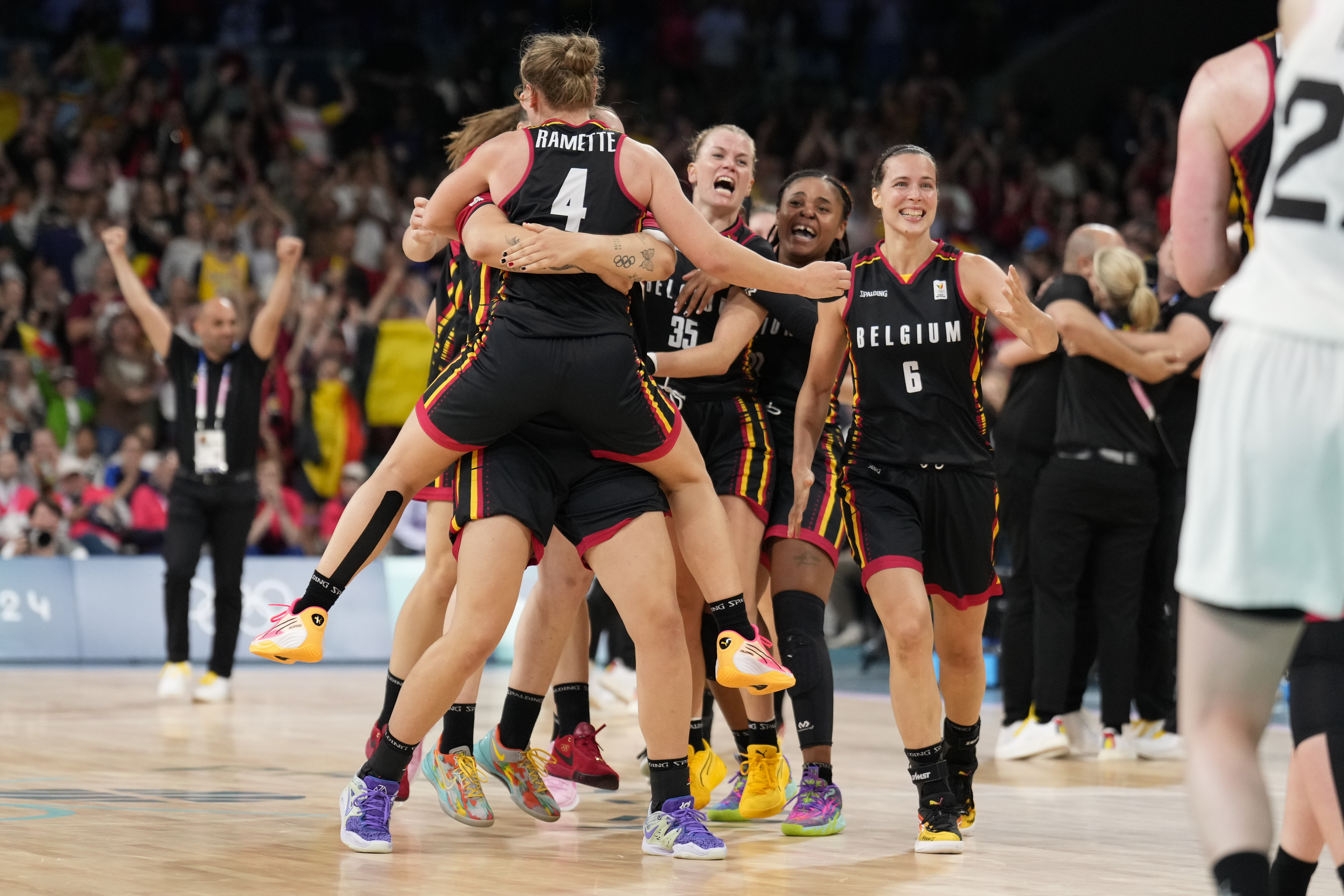 The Belgian team celebrates defeating Japan in a women's basketball game at the 2024 Summer Olympics, Sunday, Aug. 4, 2024, in Villeneuve-d'Ascq, France. 