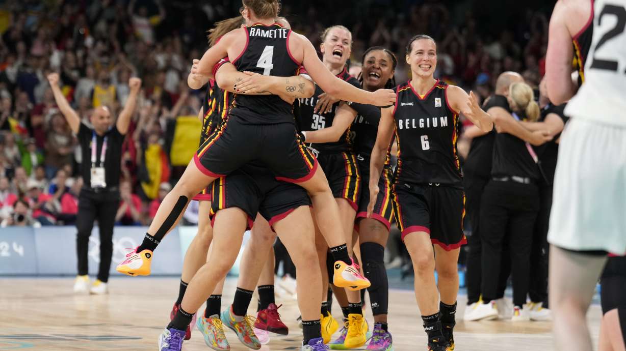 The Belgian team celebrates defeating Japan in a women's basketball game at the 2024 Summer Olympics, Sunday, Aug. 4, 2024, in Villeneuve-d'Ascq, France.