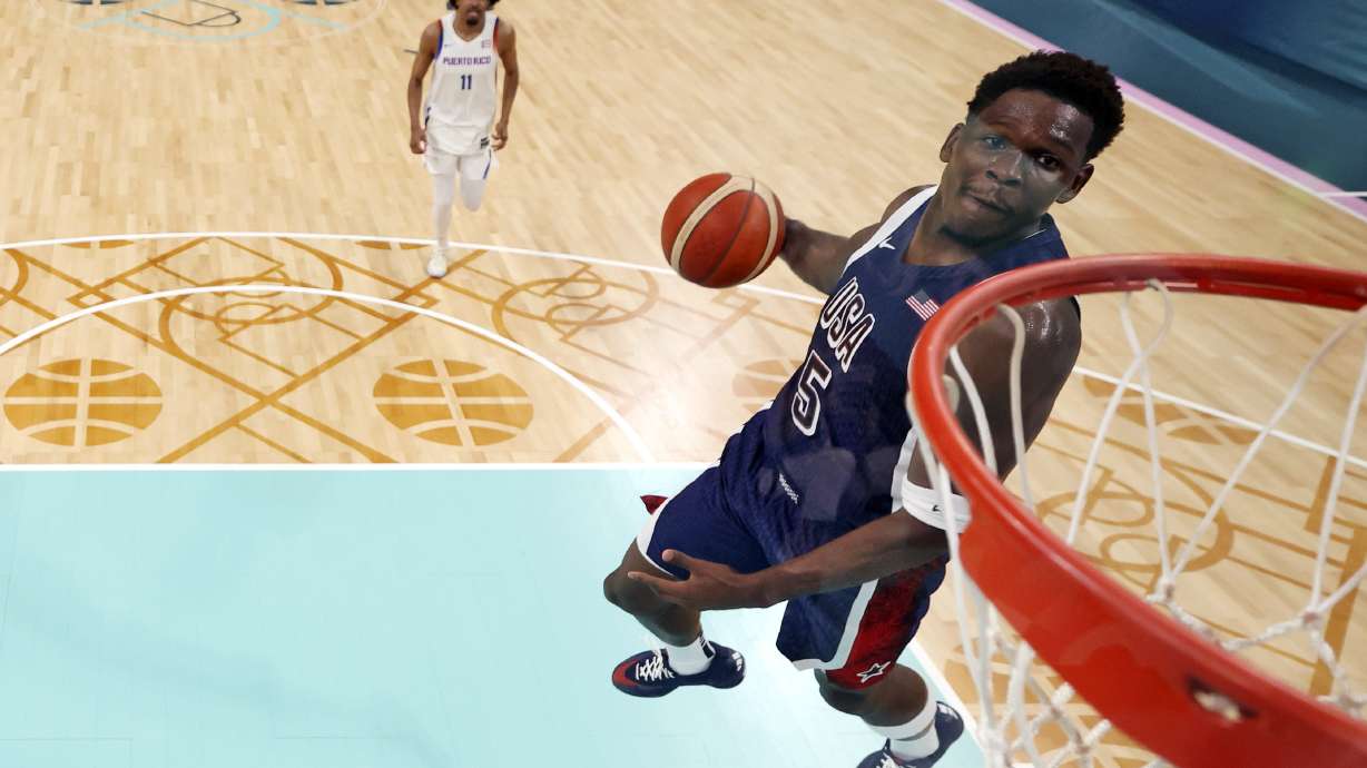United States' Anthony Edwards dunks during a men's basketball game against Puerto Rico at the 2024 Summer Olympics, Saturday, Aug. 3, 2024, in Villeneuve-d'Ascq, France.
