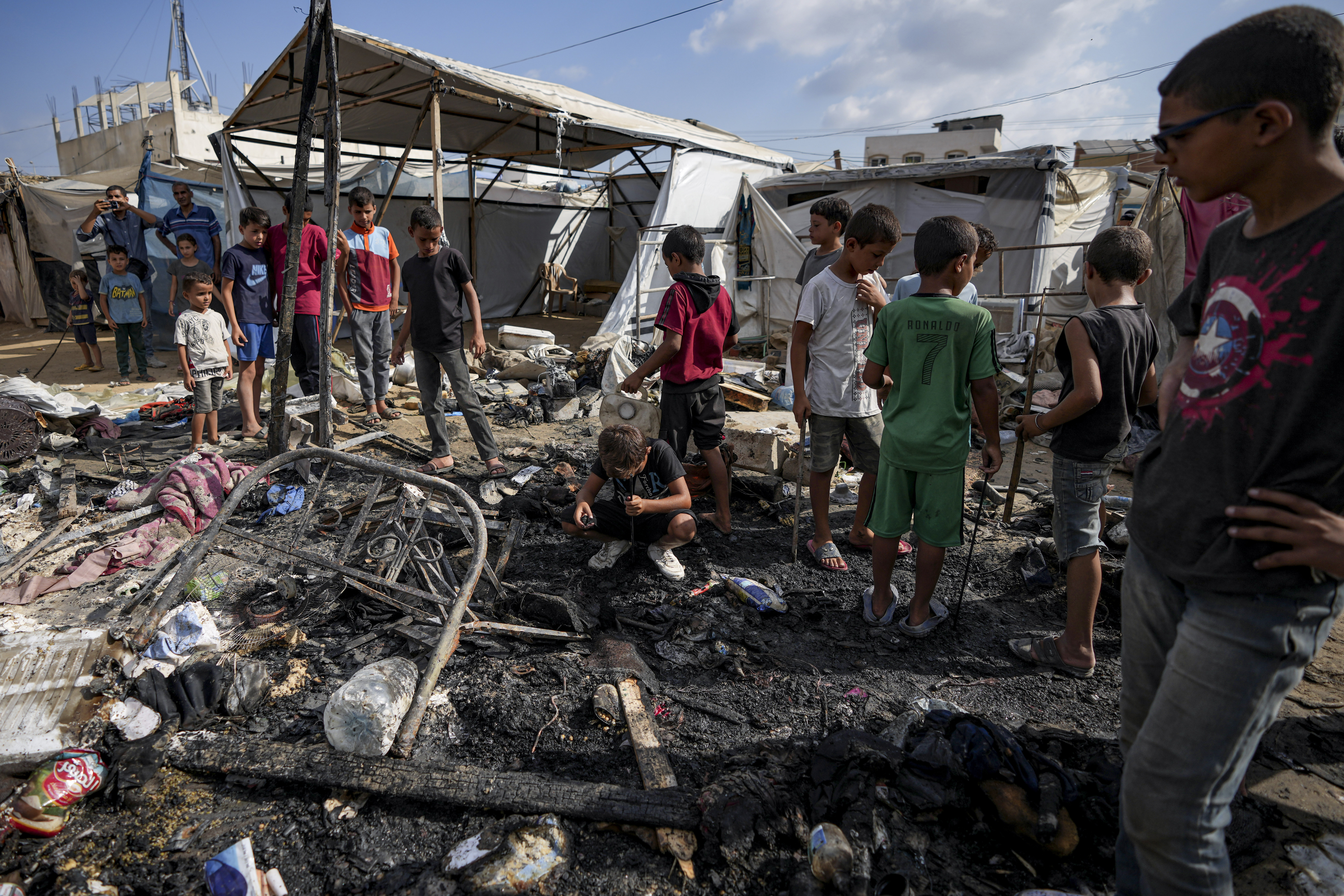Palestinians inspect the damage at a tent area in the courtyard of Al Aqsa Martyrs hospital, hit by an Israeli bombardment on Deir al-Balah, Sunday.