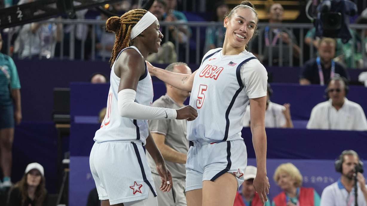 Dearica Hamby (5), of the United States, celebrates making the game winning shot with teammate Rhyne Howard (10) after a women's 3x3 basketball play-in game against China during the 2024 Summer Olympics, Saturday, Aug. 3, 2024, in Paris, France. The United States won 21-13.