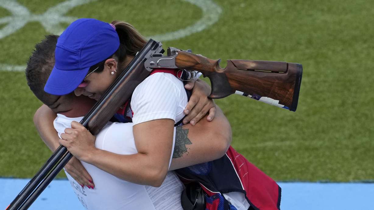 Chile's Francisca Crovetto Chadid, right, celebrates with coach after winning the gold medal in the Skeet women's final at the 2024 Summer Olympics, Sunday, Aug. 4, 2024, in Chateauroux, France.