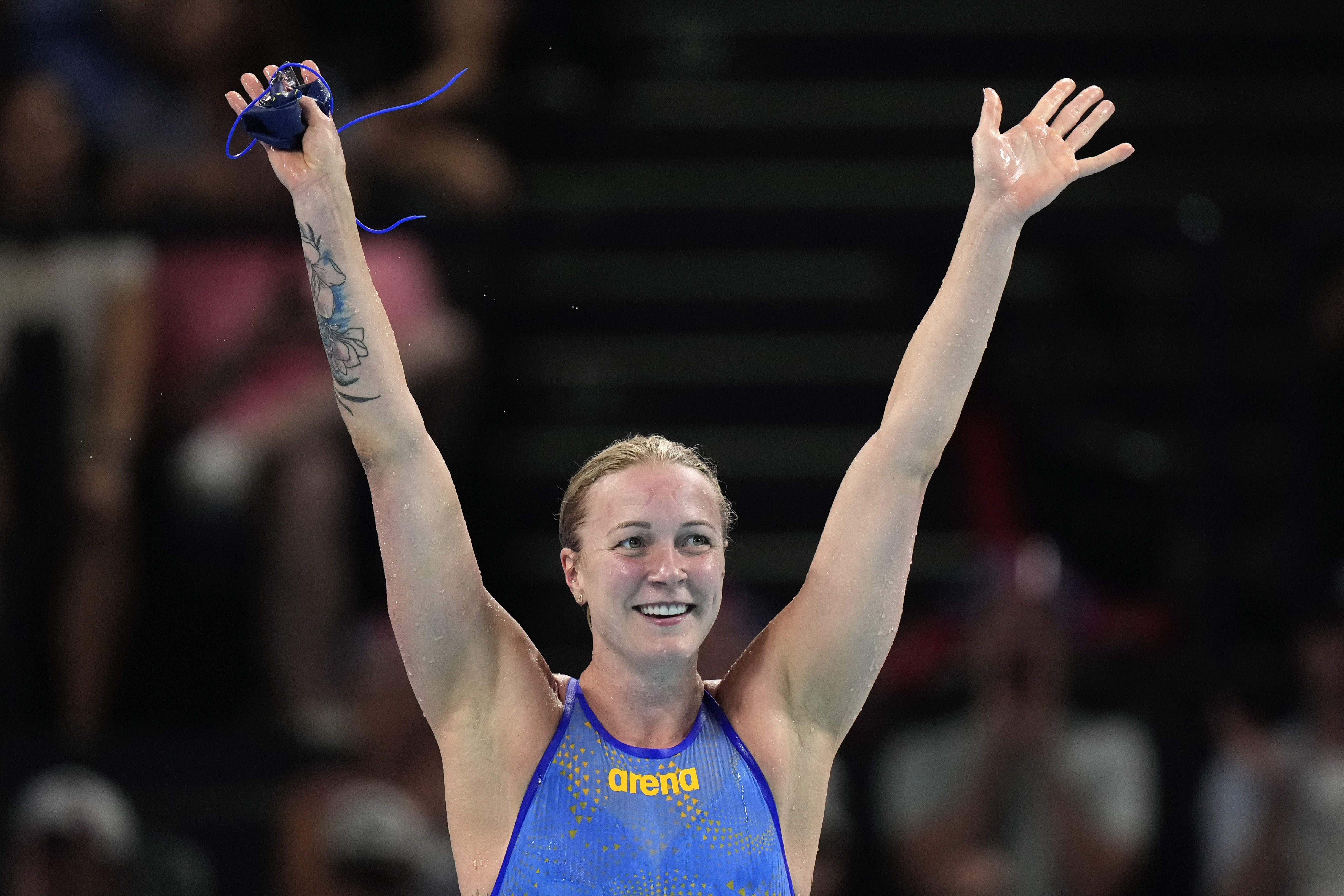 Sweden's Sarah Sjoestroem celebrates after winning the gold medal in the women's 50-meter freestyle final at the Summer Olympics in Nanterre, France, Sunday, Aug. 4, 2024. 