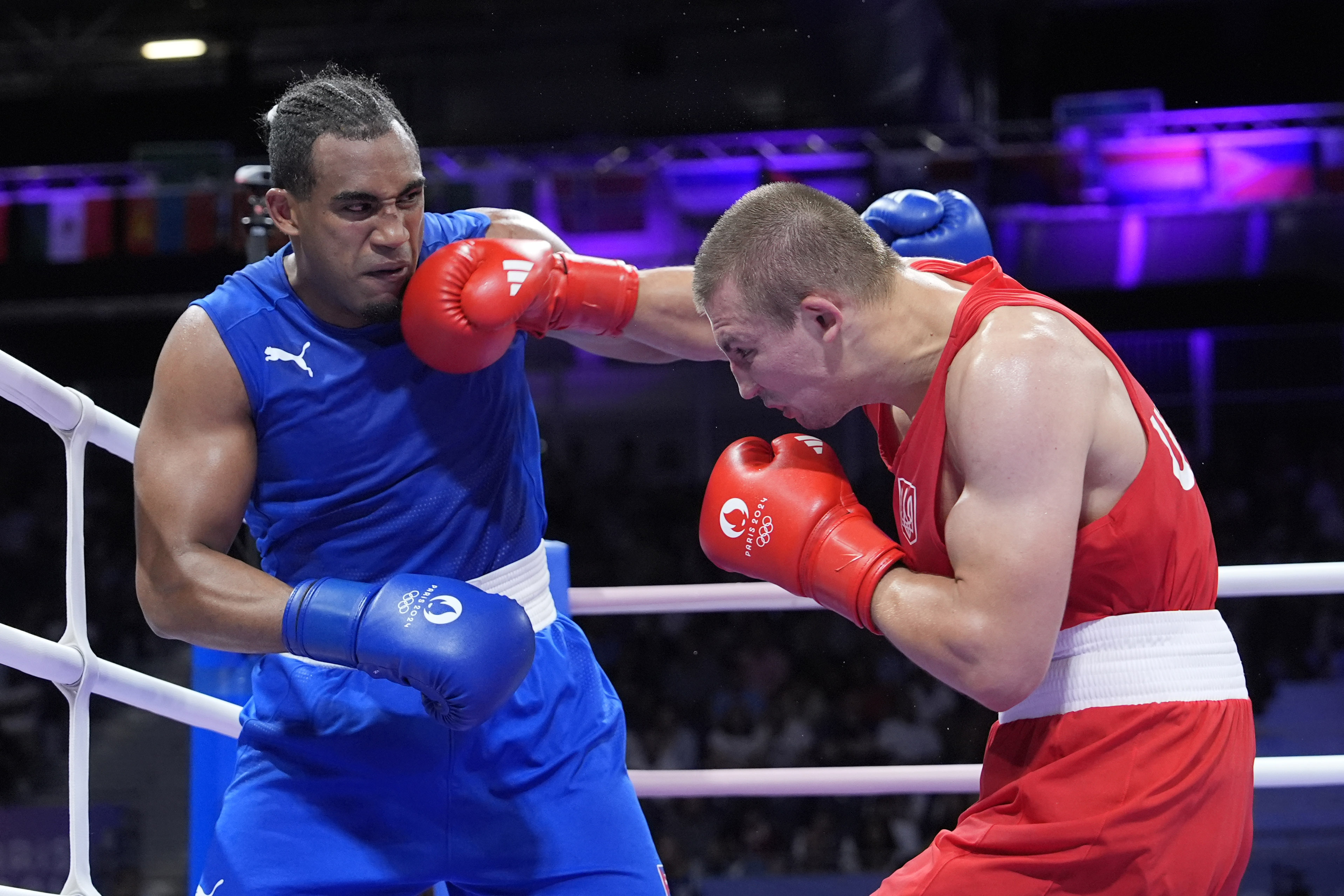 Ukraine's Oleksandr Khyzhniak hits Cuba's Arlen Lopez in their men's 80 kg semifinal boxing match at the 2024 Summer Olympics, Sunday, Aug. 4, 2024, in Paris, France. 