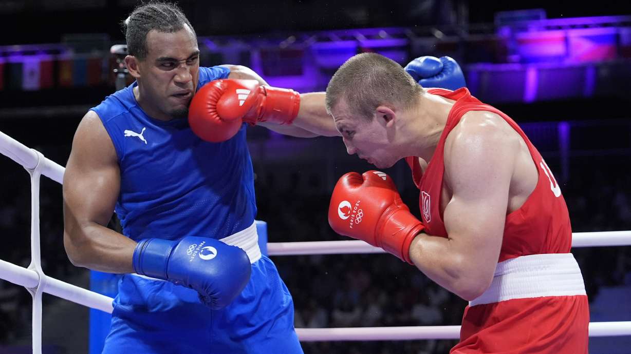 Ukraine's Oleksandr Khyzhniak hits Cuba's Arlen Lopez in their men's 80 kg semifinal boxing match at the 2024 Summer Olympics, Sunday, Aug. 4, 2024, in Paris, France.