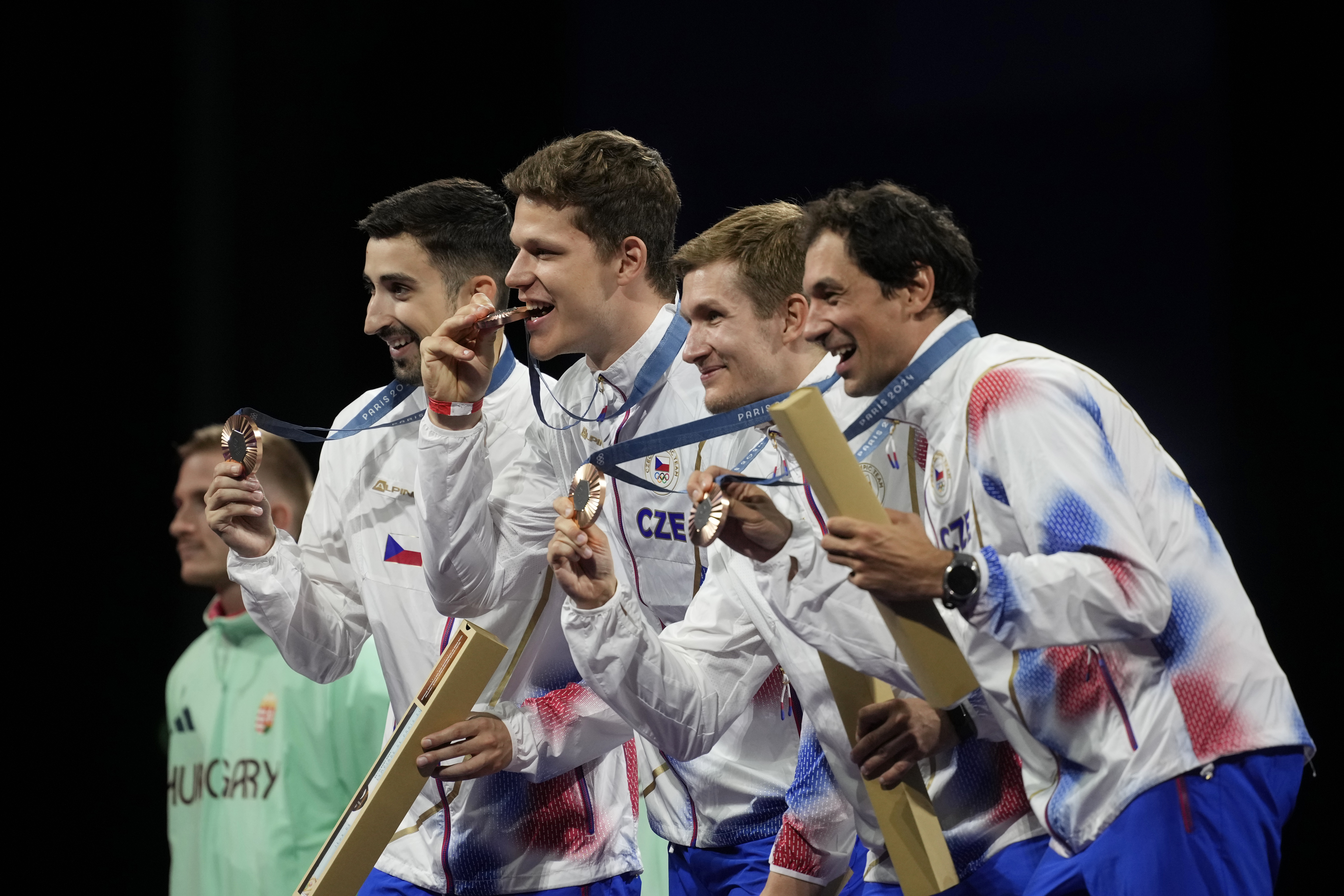 Czech Republic's fencers Jiri Beran, Jakub Jurka, Martin Rubes and Michal Cupr celebrate on the podium after winner the bronze medal in the men's team epee competition during the 2024 Summer Olympics at the Grand Palais, Friday, Aug. 2, 2024, in Paris, France.