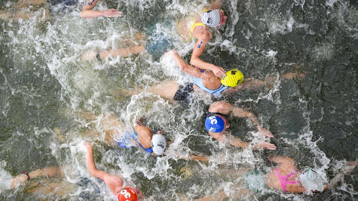 Australia's Natalie Van Coevorden (15), Belgium's Claire Michel (5) and Ekaterina Shabalina, of Kazakhstan (32) compete in the swim leg of the women's individual triathlon competition at the 2024 Summer Olympics, Wednesday, July 31, 2024, in Paris, France.