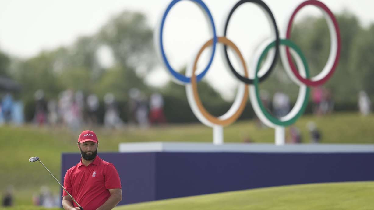 Jon Rahm, of Spain, watches his putt on the 18th green during the final round of the men's golf at the 2024 Summer Olympics, Sunday, Aug. 4, 2024, at Le Golf National in Saint-Quentin-en-Yvelines, France. Scottie Scheffler, of the United States, wins the gold medal with Tommy Fleetwood, of Britain, silver and Hideki Matsuyama, of Japan, the bronze.