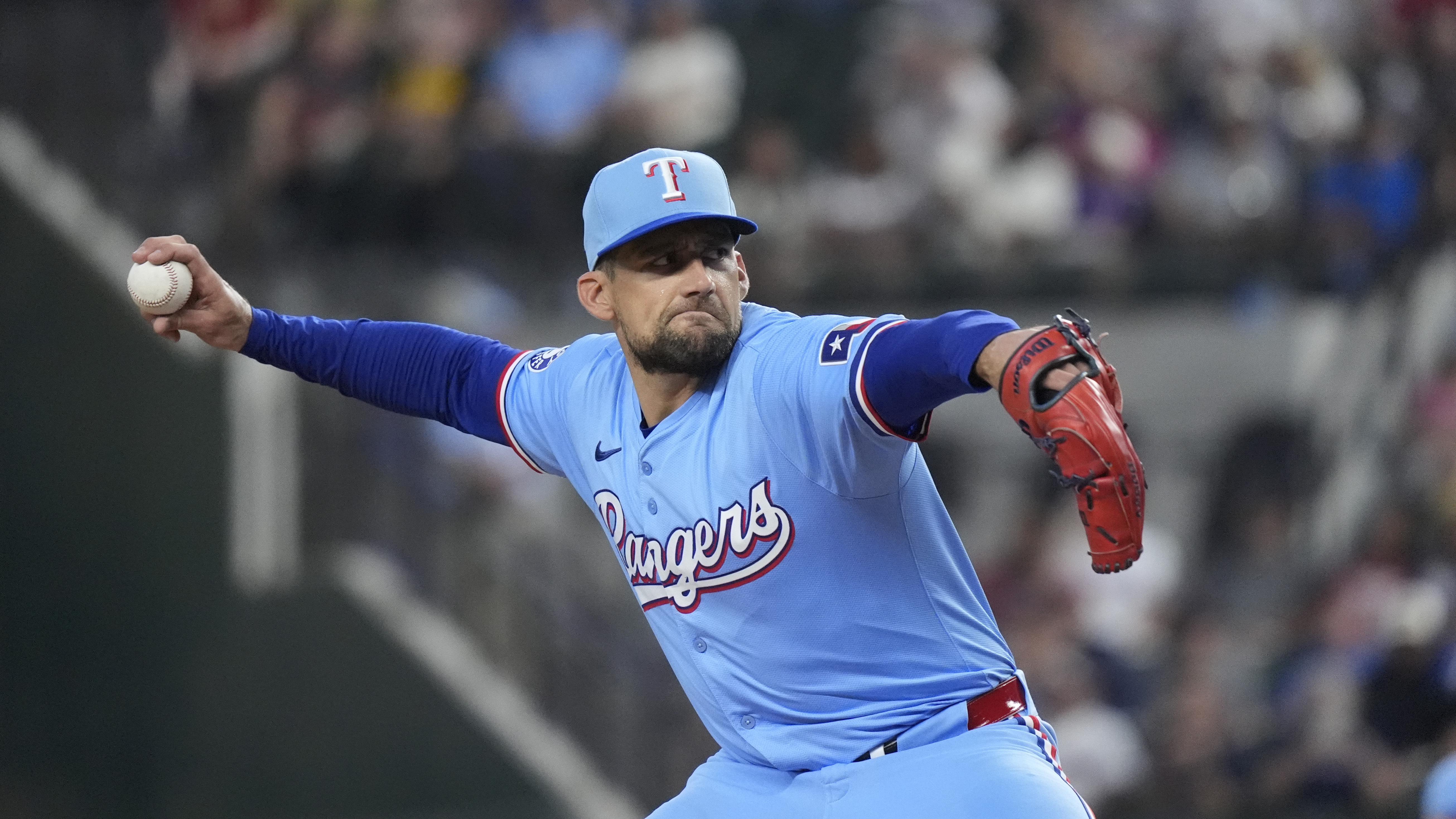 Texas Rangers starting pitcher Nathan Eovaldi throws during the first inning of a baseball game against the Boston Red Sox in Arlington, Texas, Sunday, Aug. 4, 2024. 