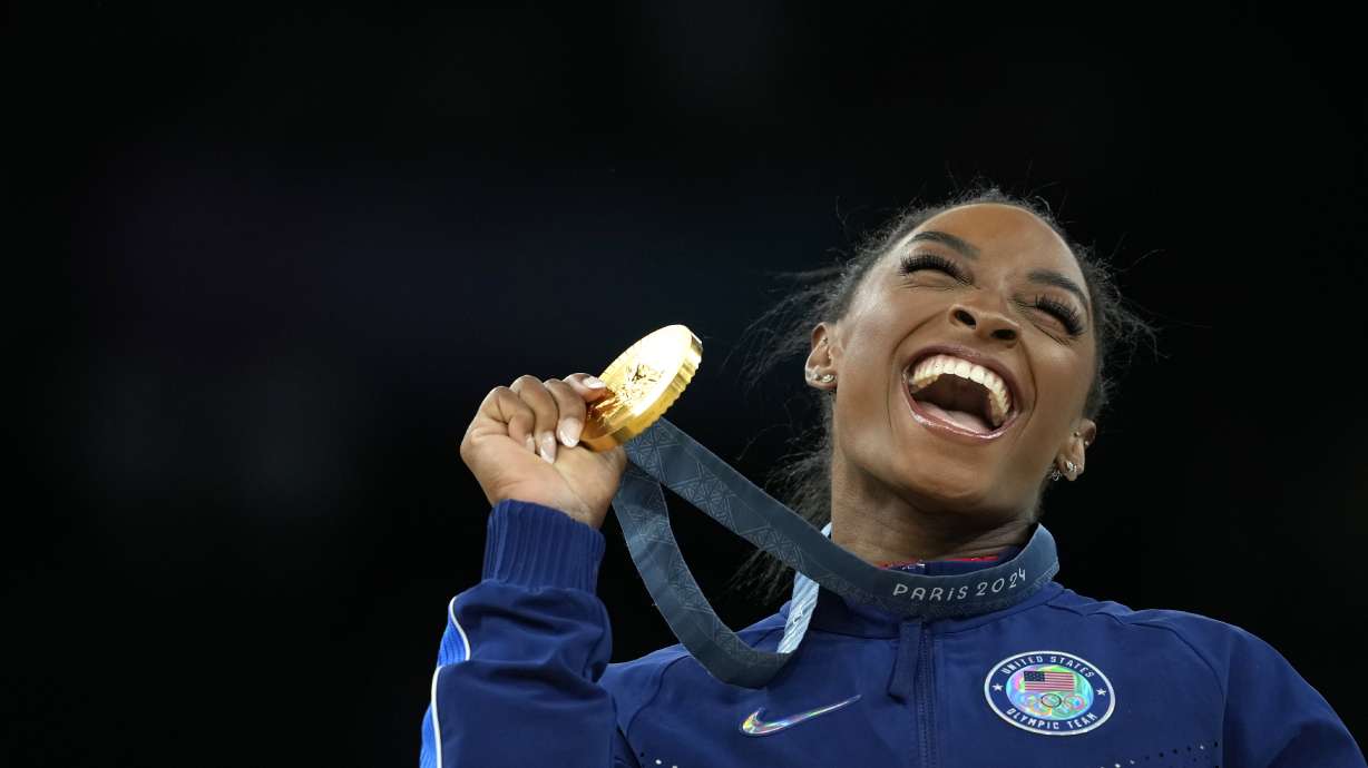 Simone Biles, of the United States, celebrates after winning the gold medal at the medal ceremony during the women's artistic gymnastics individual vault finals at Bercy Arena at the 2024 Summer Olympics, Saturday, Aug. 3, 2024, in Paris, France.