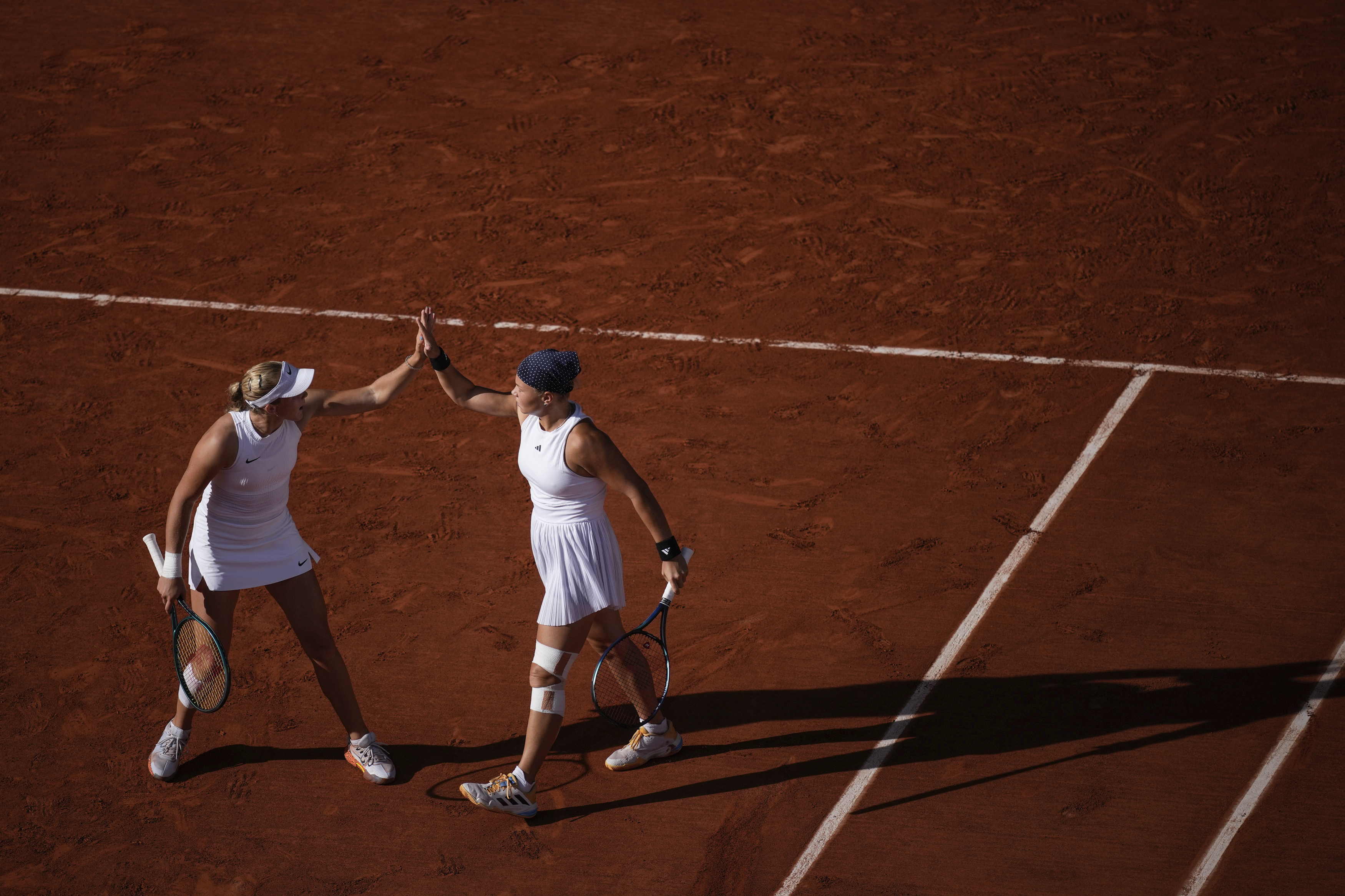 Mirra Andreeva and Diana Shnaider of Individual Neutral Athlete react as they play against Sara Errani and Jasmine Paolini of Italy during women's doubles gold medal tennis match at the Roland Garros stadium, at the 2024 Summer Olympics, Sunday, Aug. 4, 2024, in Paris, France. 